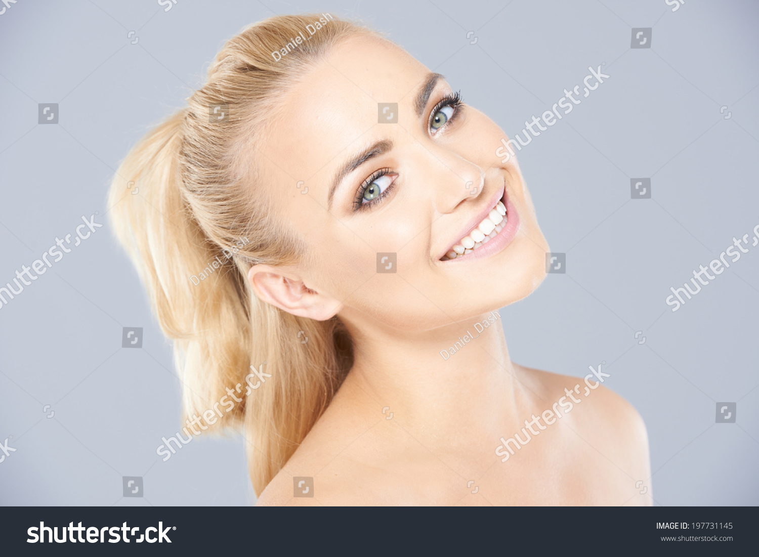 Beautiful Young Blond Woman With Her Hair In A Ponytail Posing With