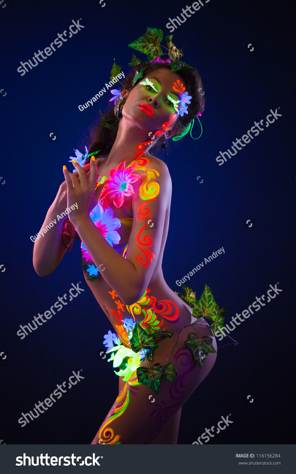 Beautiful Flowers In UV Light On A Young Girl Face And 