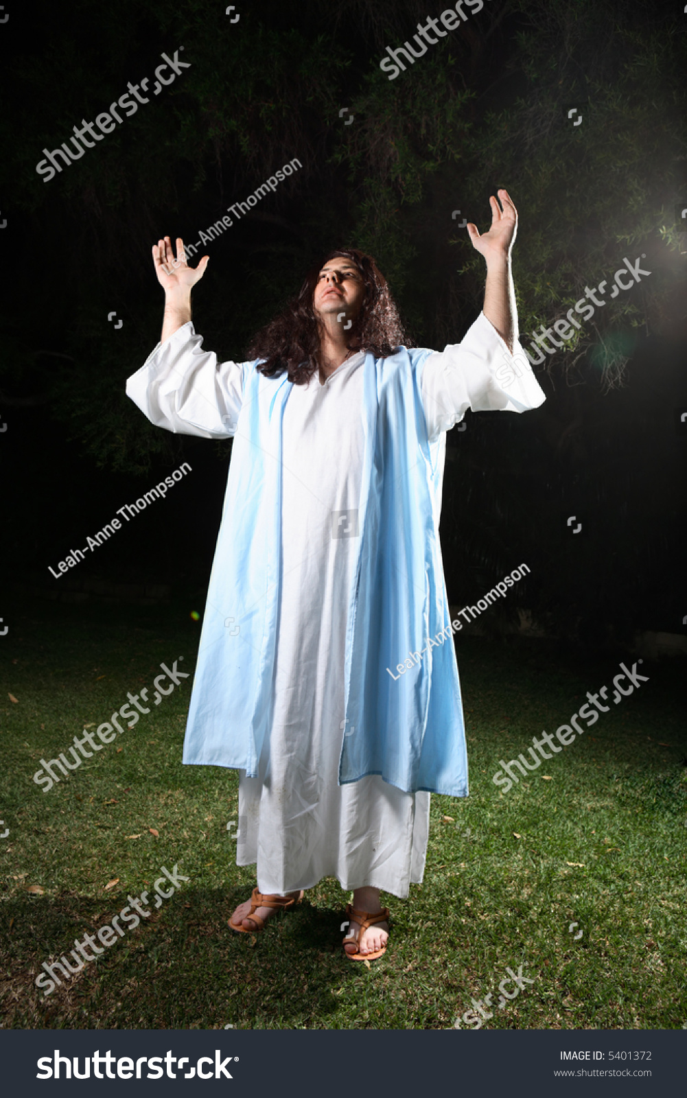 Biblical Man Wearing White Robe And Over Cloak Bathed In Light Praising