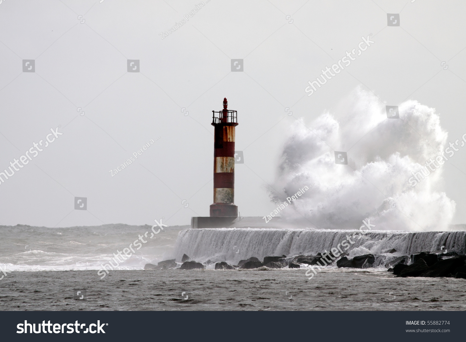 Big Wave Against Lighthouse In The North Of Portugal Stock Photo