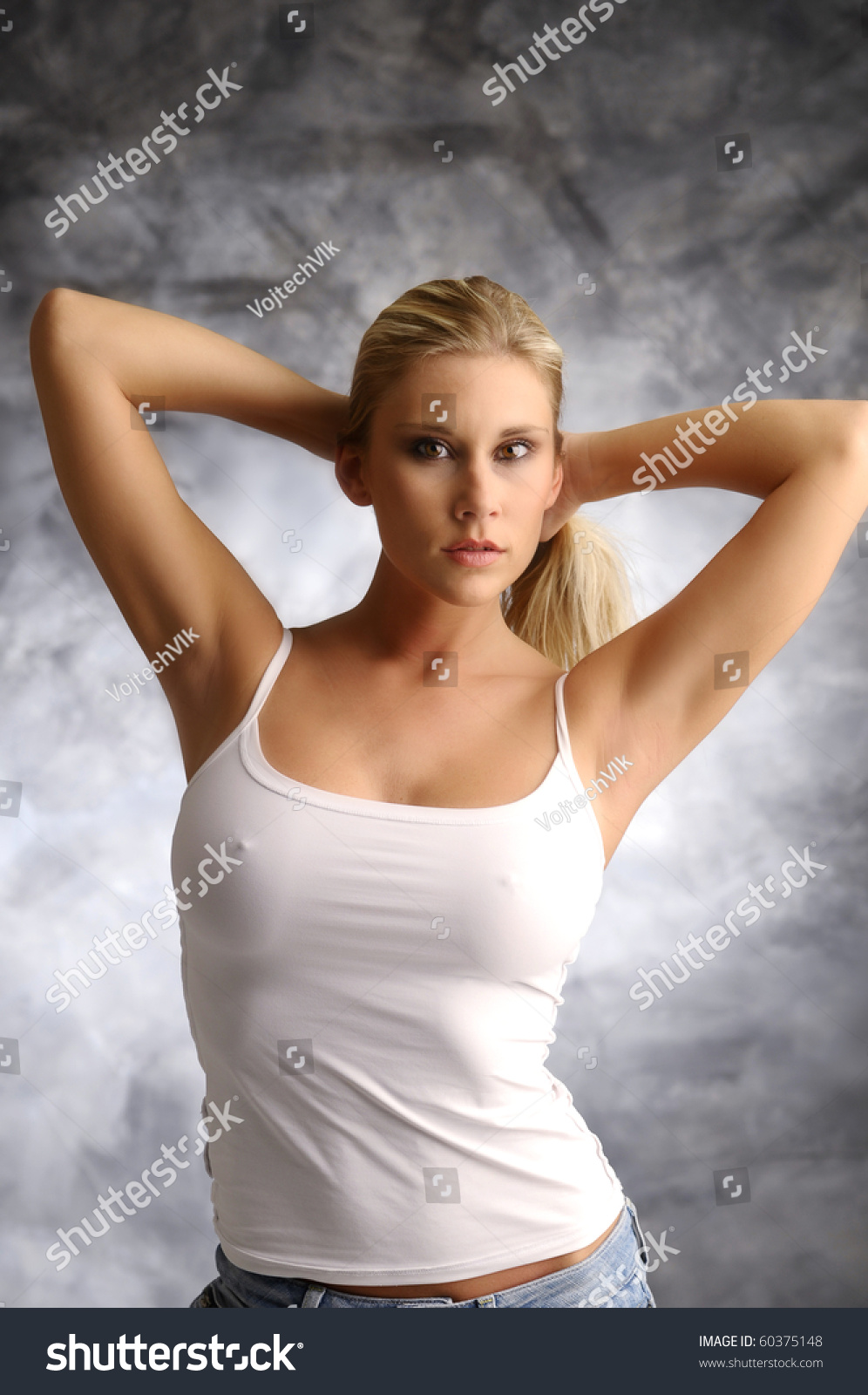 Blonde Girl In White Shirt On Smoky Background Stock Photo