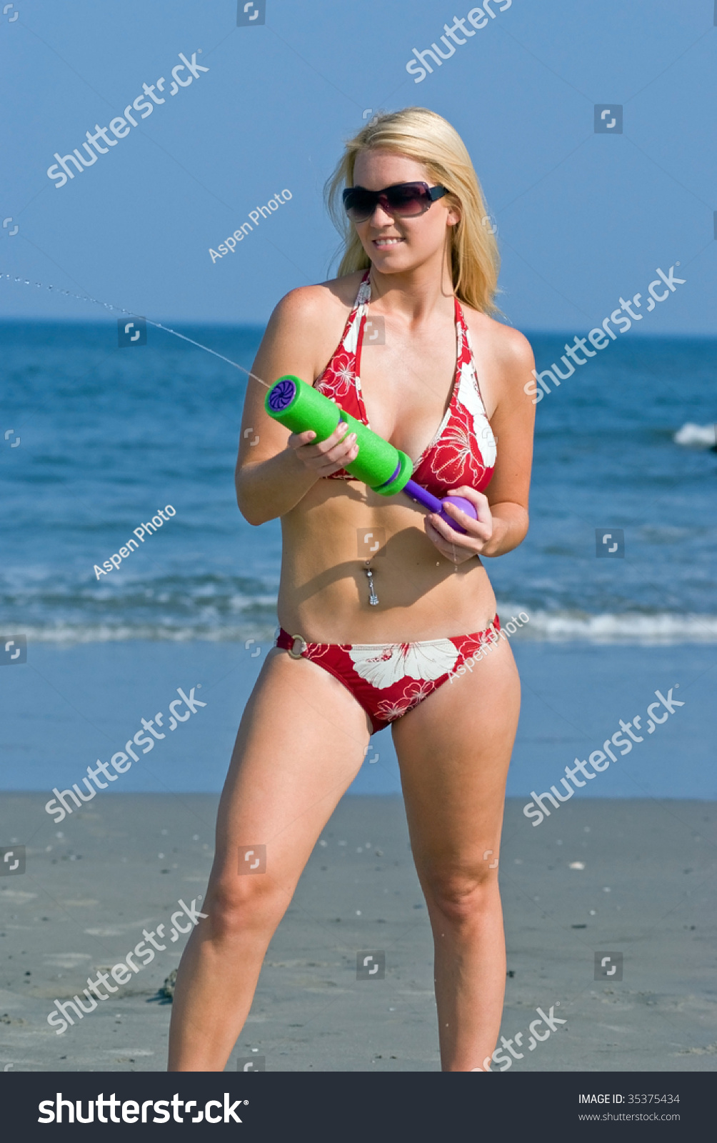 Blonde Woman In Red Bikini Firing