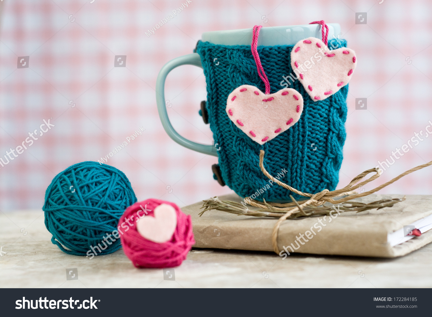 stock-photo-blue-cup-in-a-blue-sweater-with-felt-hearts-172284185.jpg