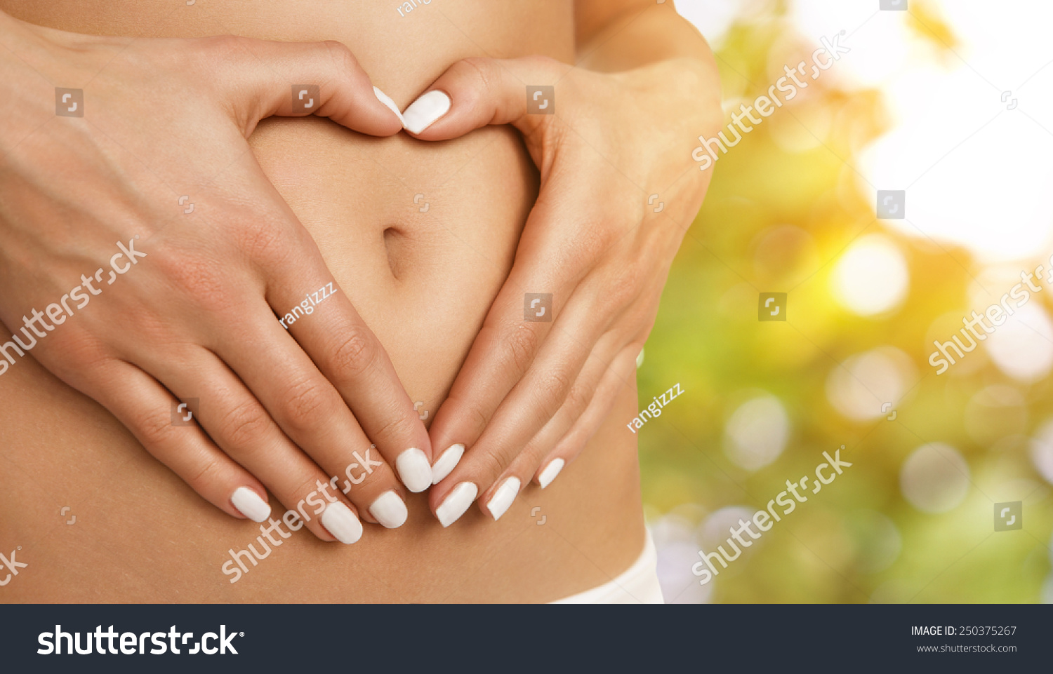 Body care pregnancy diet concept female hands forming heart shape on the stomach Body care pregnancy diet concept female hands forming heart shape on the stomach