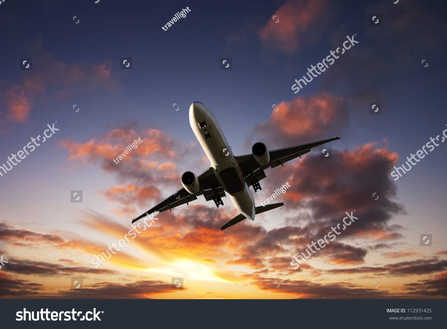 Boeing 777 Jet Aeroplane Landing From Bright Dramatic Sunset Moody Sky 