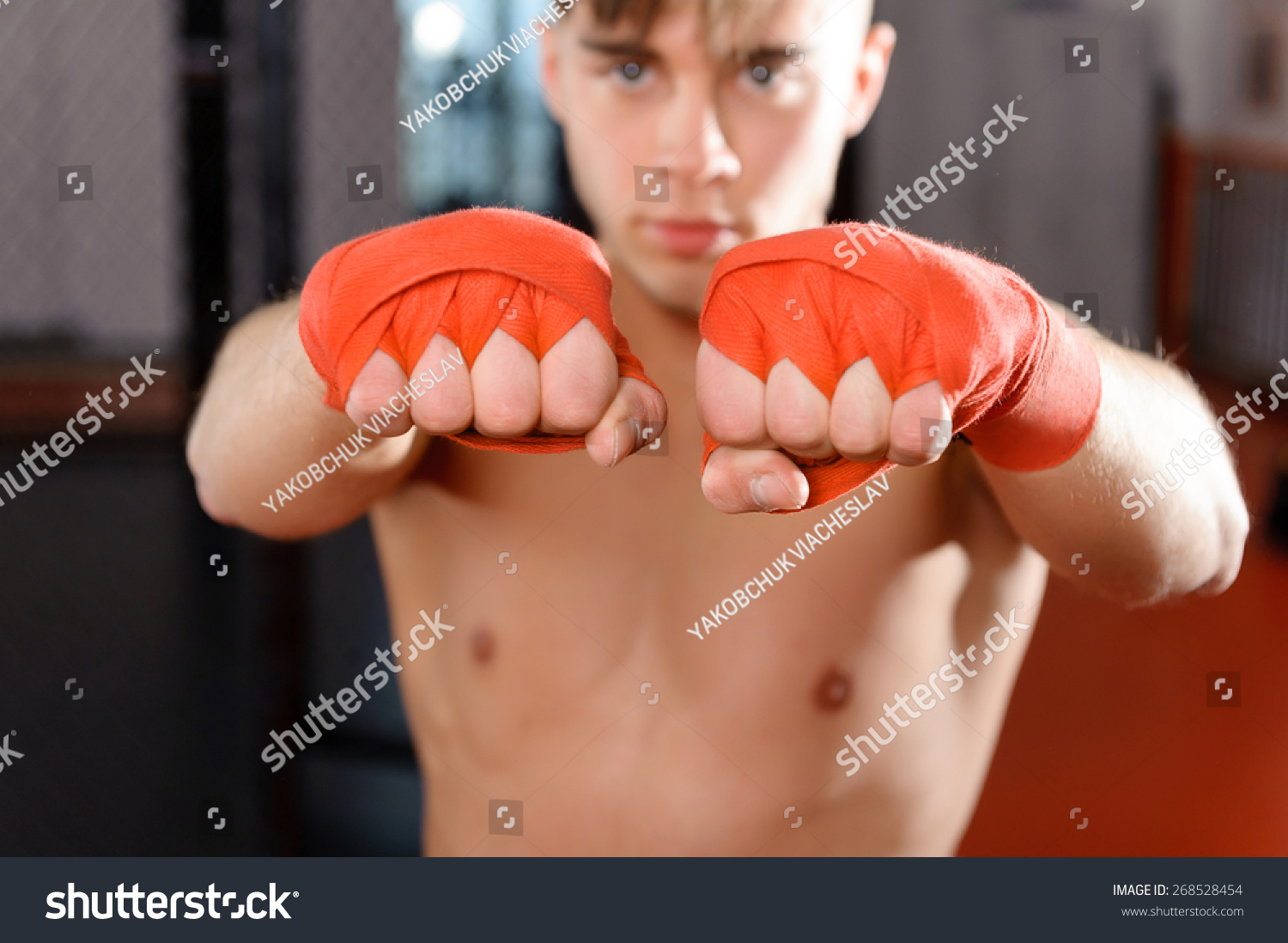 Boxing Bandages. Selective Focus On Fists Of A Young Handsome Fighter