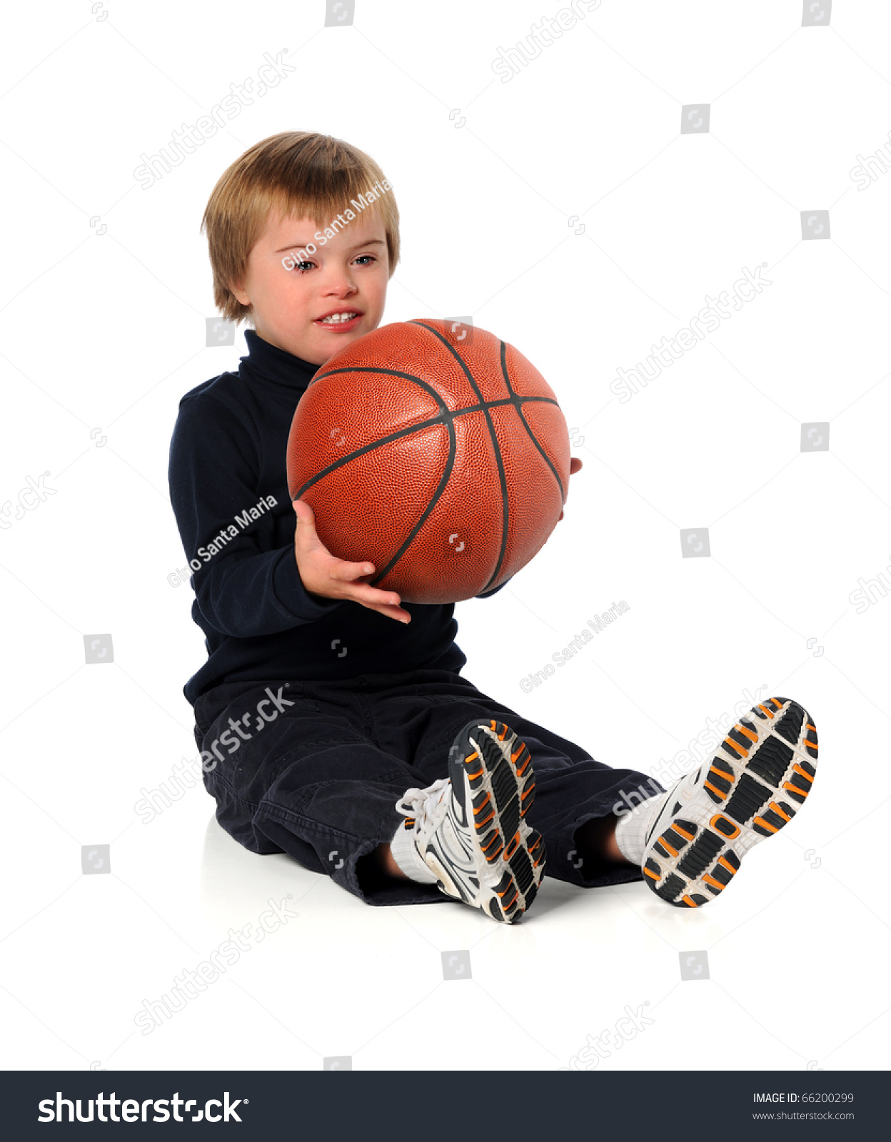 Boy With Down Syndrome Playing With Basketball Over White Background