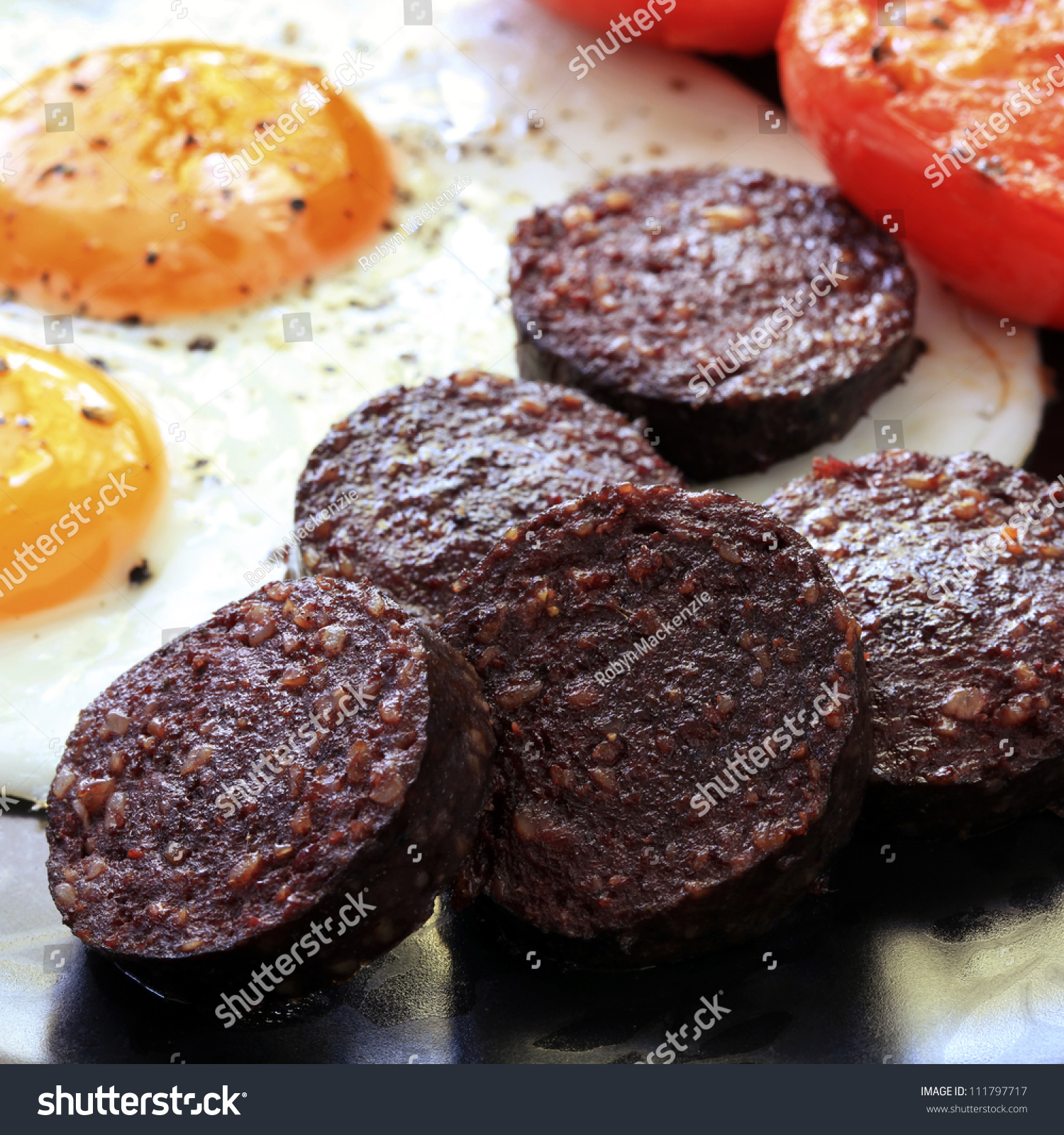 breakfast-of-traditional-black-pudding-fried-eggs-and-tomatoes-stock