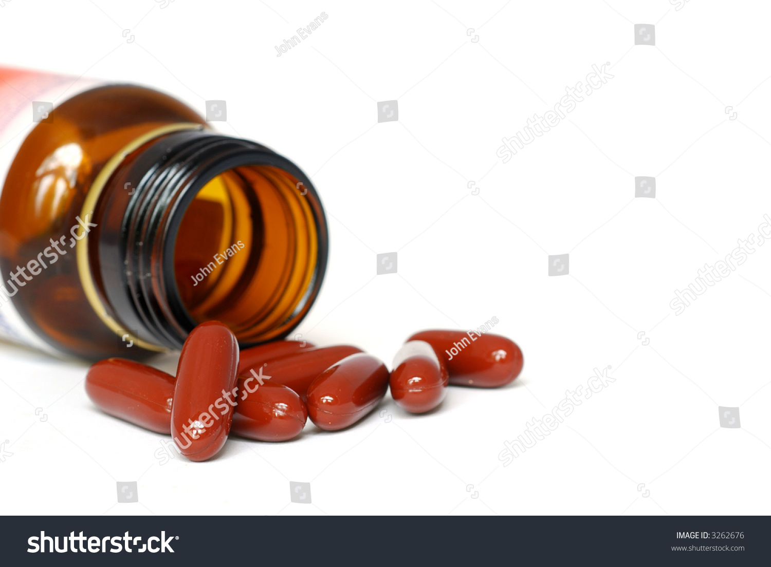 Brown Capsules Spilling Out Of A Brown Medicine Bottle Stock Photo