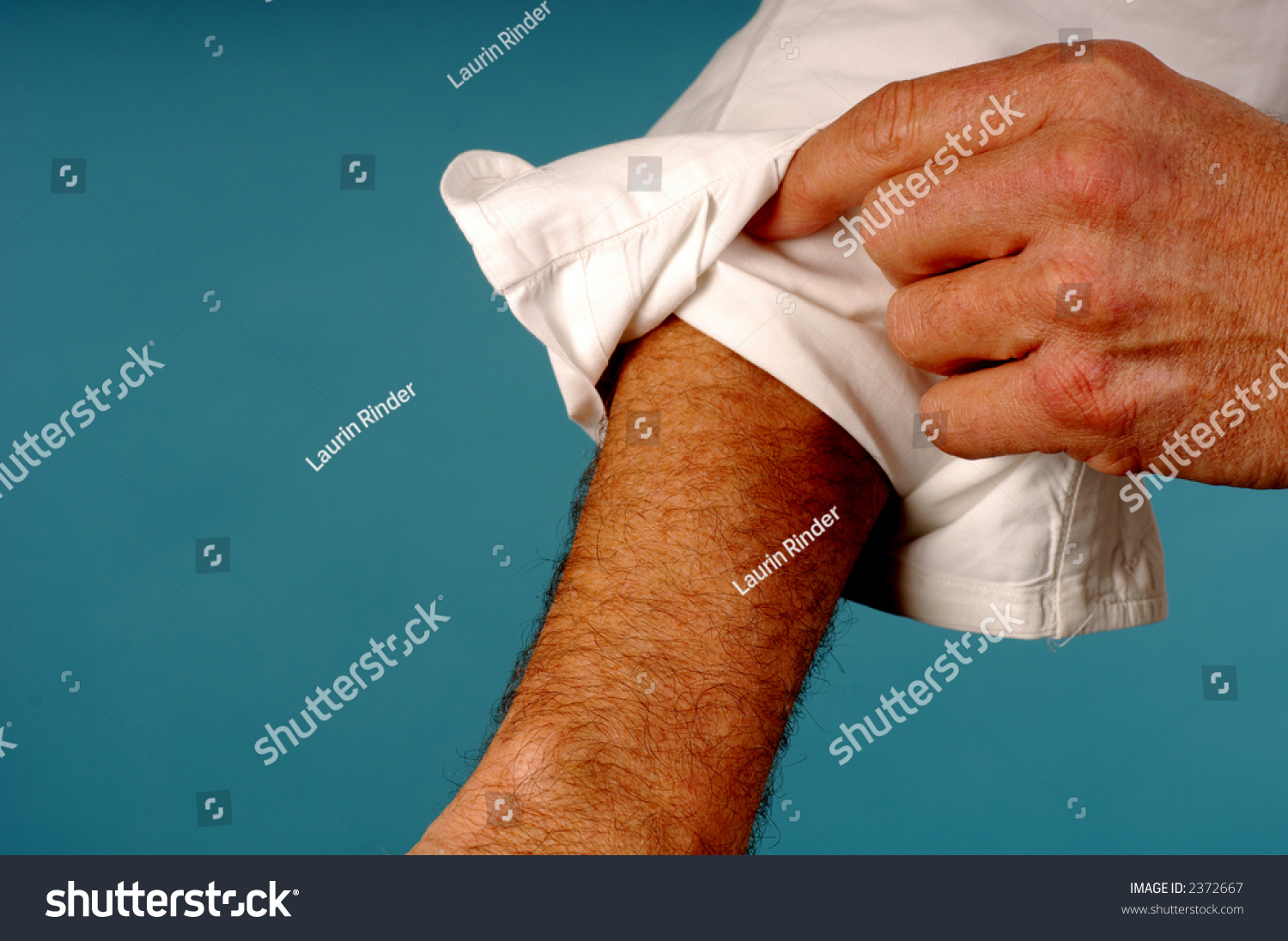 men rolling up sleeves