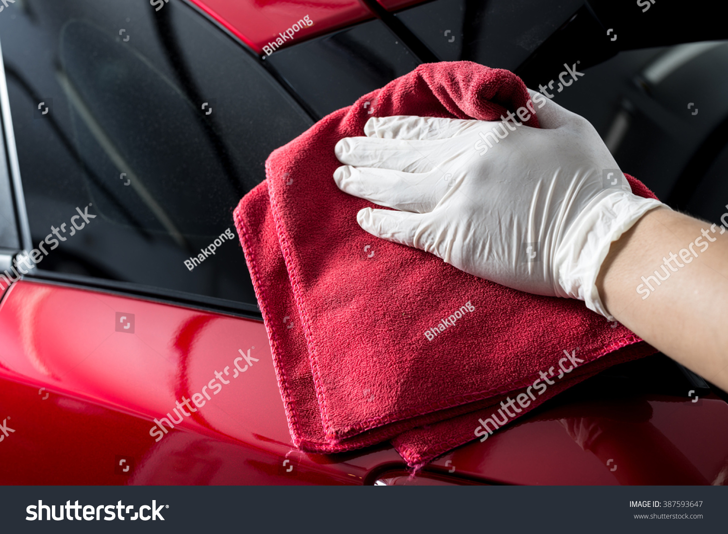 Car detailing series Worker cleaning red car Car detailing series Worker cleaning red car