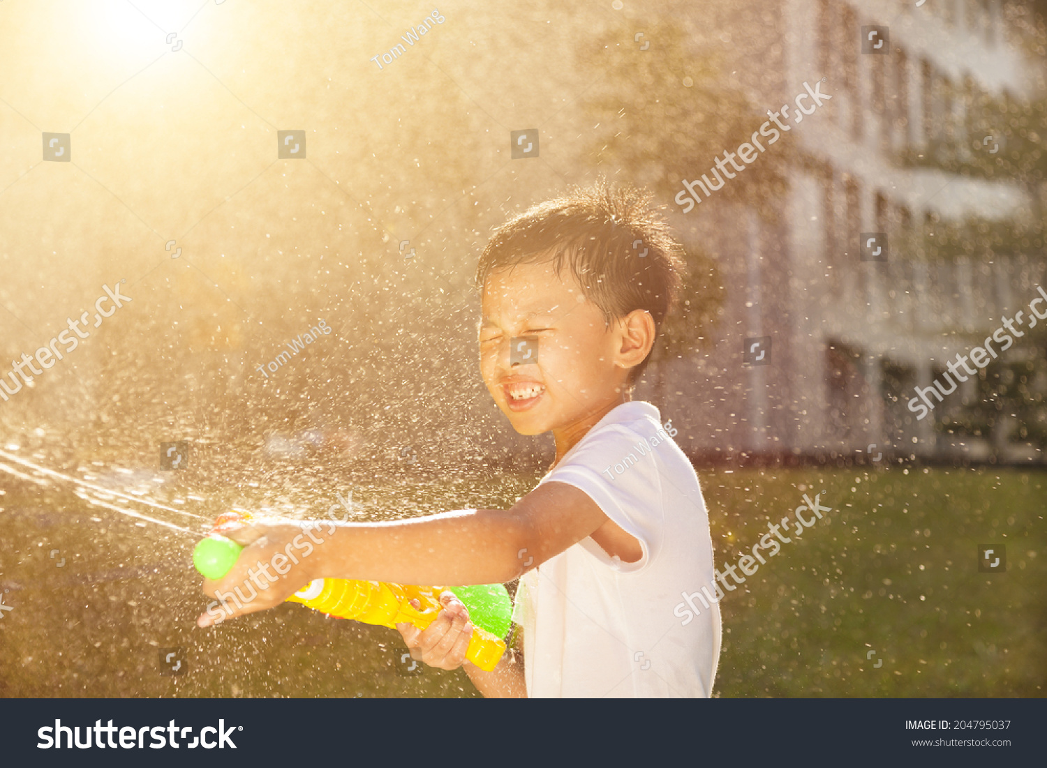 stock-photo-cheerful-little-boy-playing-water-guns-in-the-park-204795037.jpg