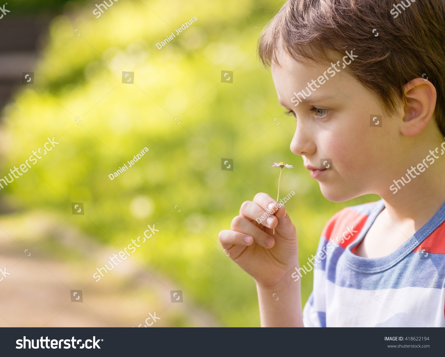 Save to a lightbox - stock-photo-children-s-day-sweet-little-boy-smelling-a-daisy-in-the-park-418622194