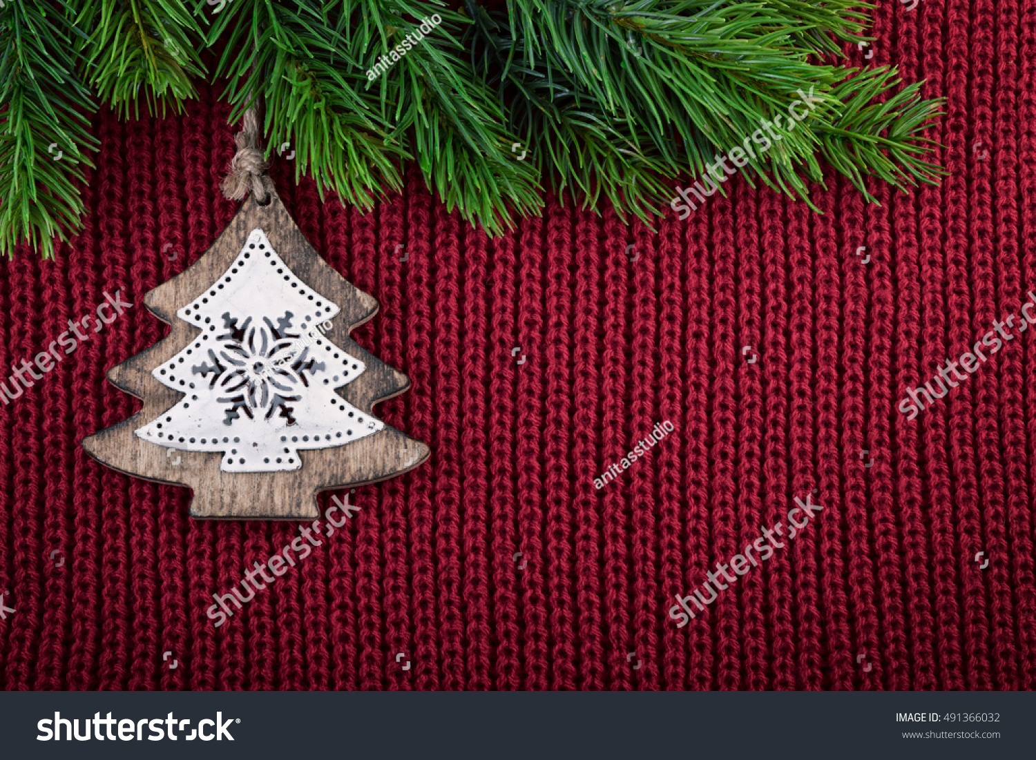 Christmas Red Knitted Background With Christmas Tree Decoration In