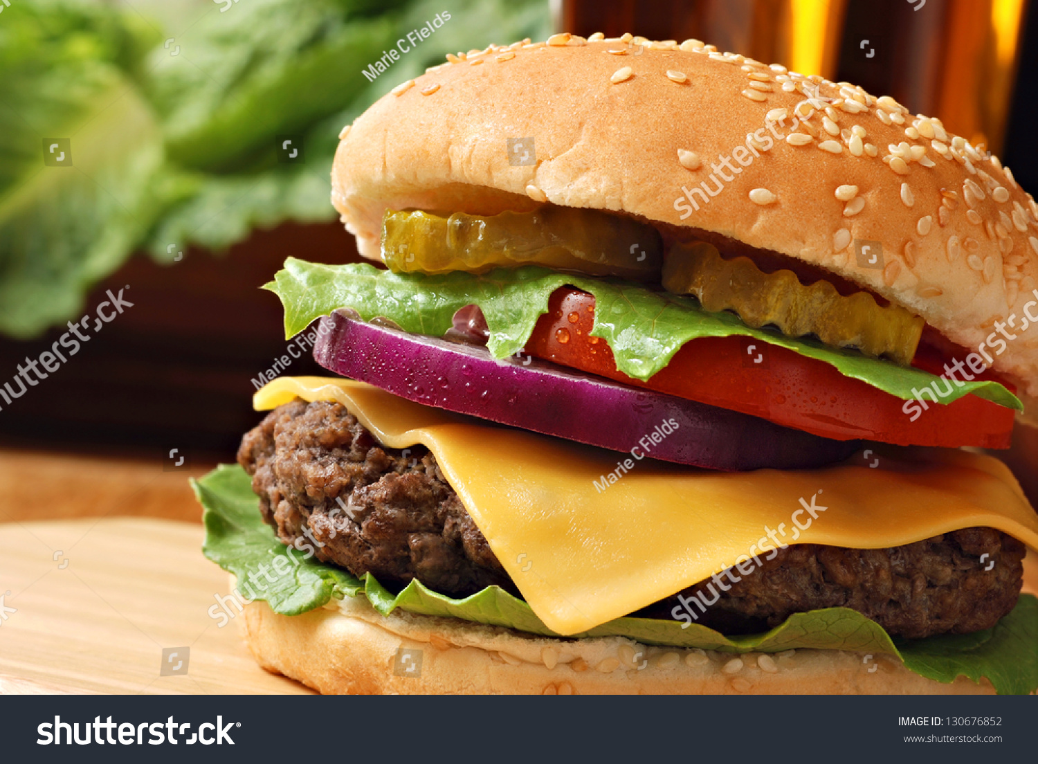 Classic Deluxe Cheeseburger With Lettuce Onions Tomato And Pickles On