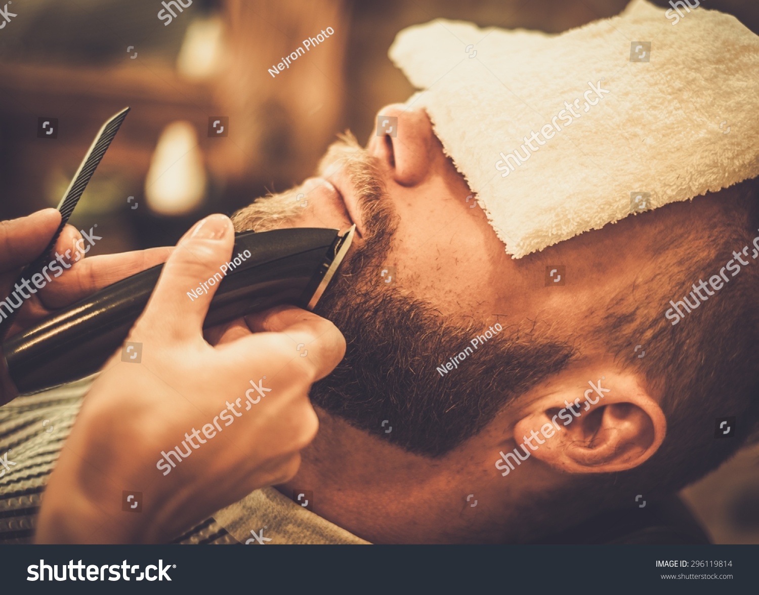 Client during beard and moustache grooming in barber shop Client during beard and moustache grooming in barber shop