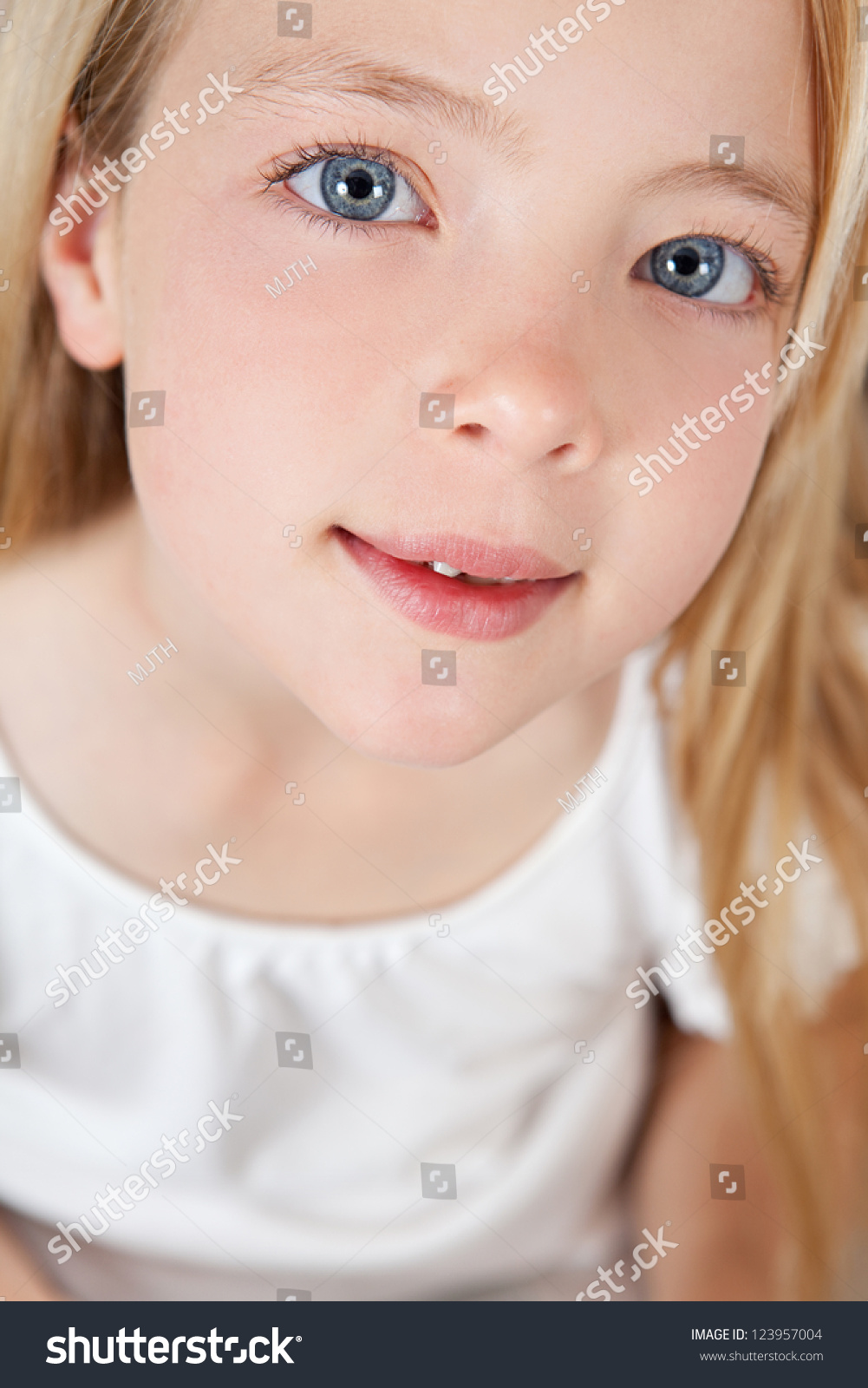 Close Up Beauty Portrait Of A Young Girl Looking Innocent And Smiling