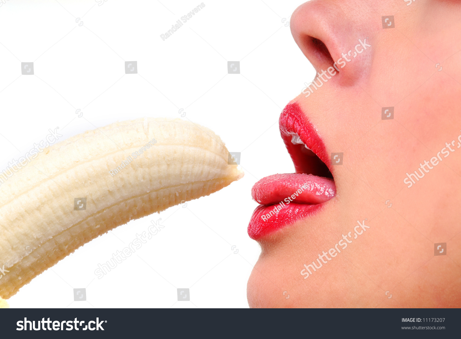 CloseUp Female Lips With Red Lipstick And Peeled Banana Stock