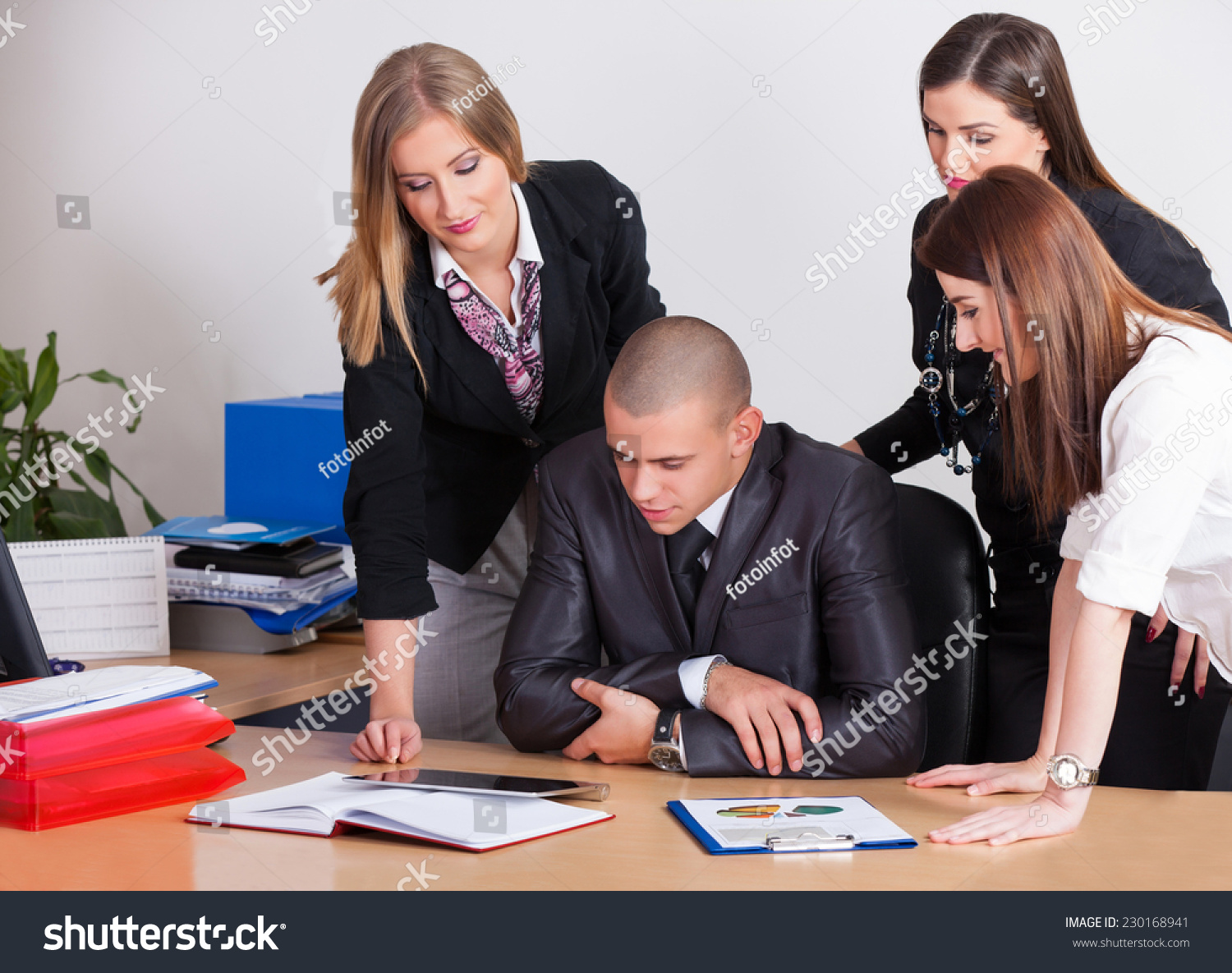 Close-up of a modern business team using tablet computer to work with financial data in office Close-up of a modern business team using tablet computer to work with financial data in office