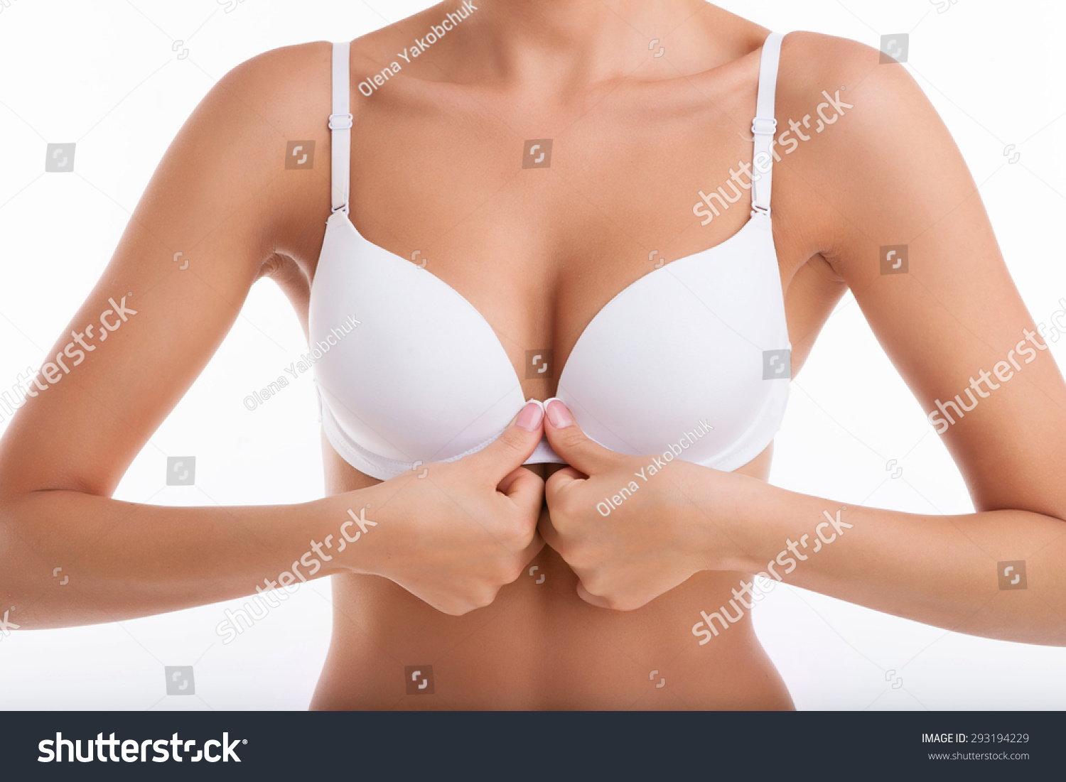 Close Up Of Breast Of Fit Woman Unbuttoning Her White Bra In Front O