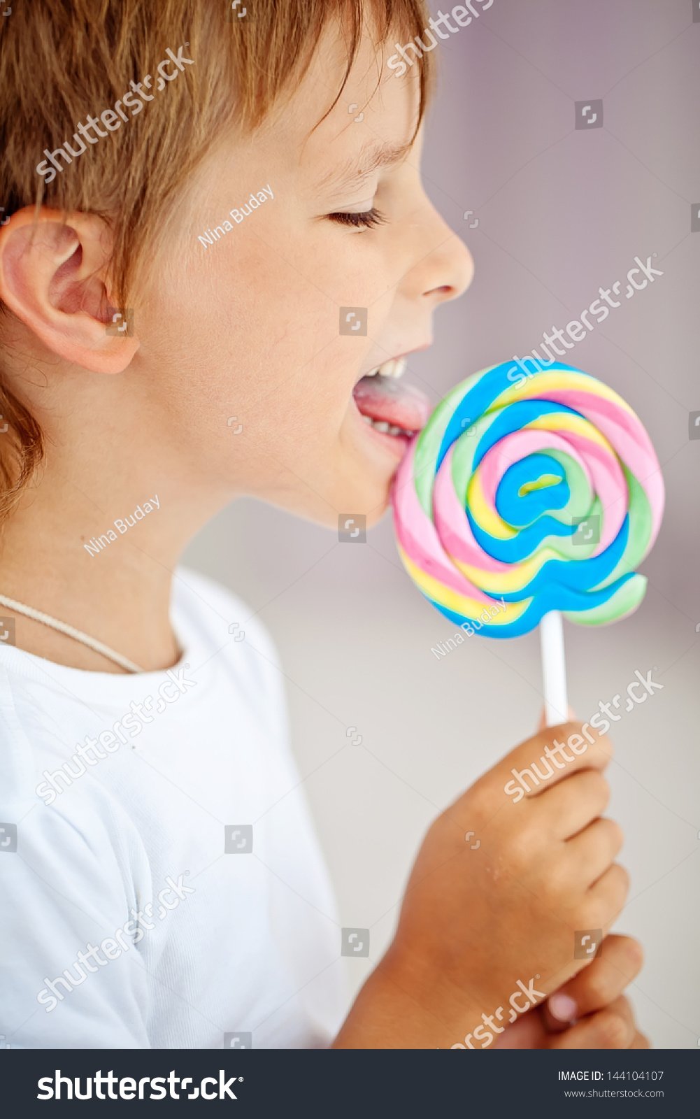 Close Young Boy Eating Lollipop Stock Photo 144104107 - Shutterstock