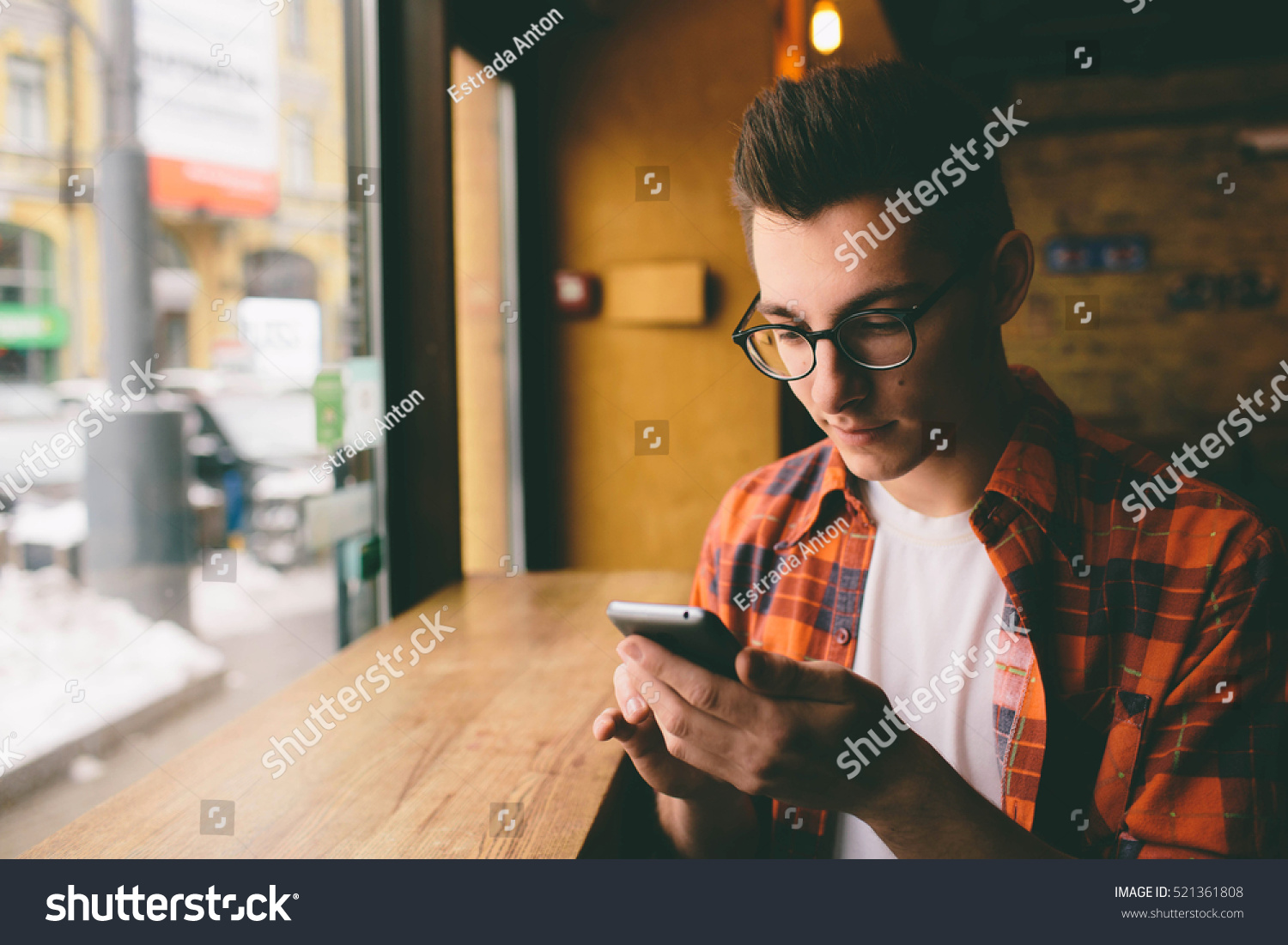 Close up on the hands of a young handsome man using a smartphone tapping the screen technology social network communication concept Close up on the hands of a young handsome man using a smartphone tapping the screen technology social network communication concept