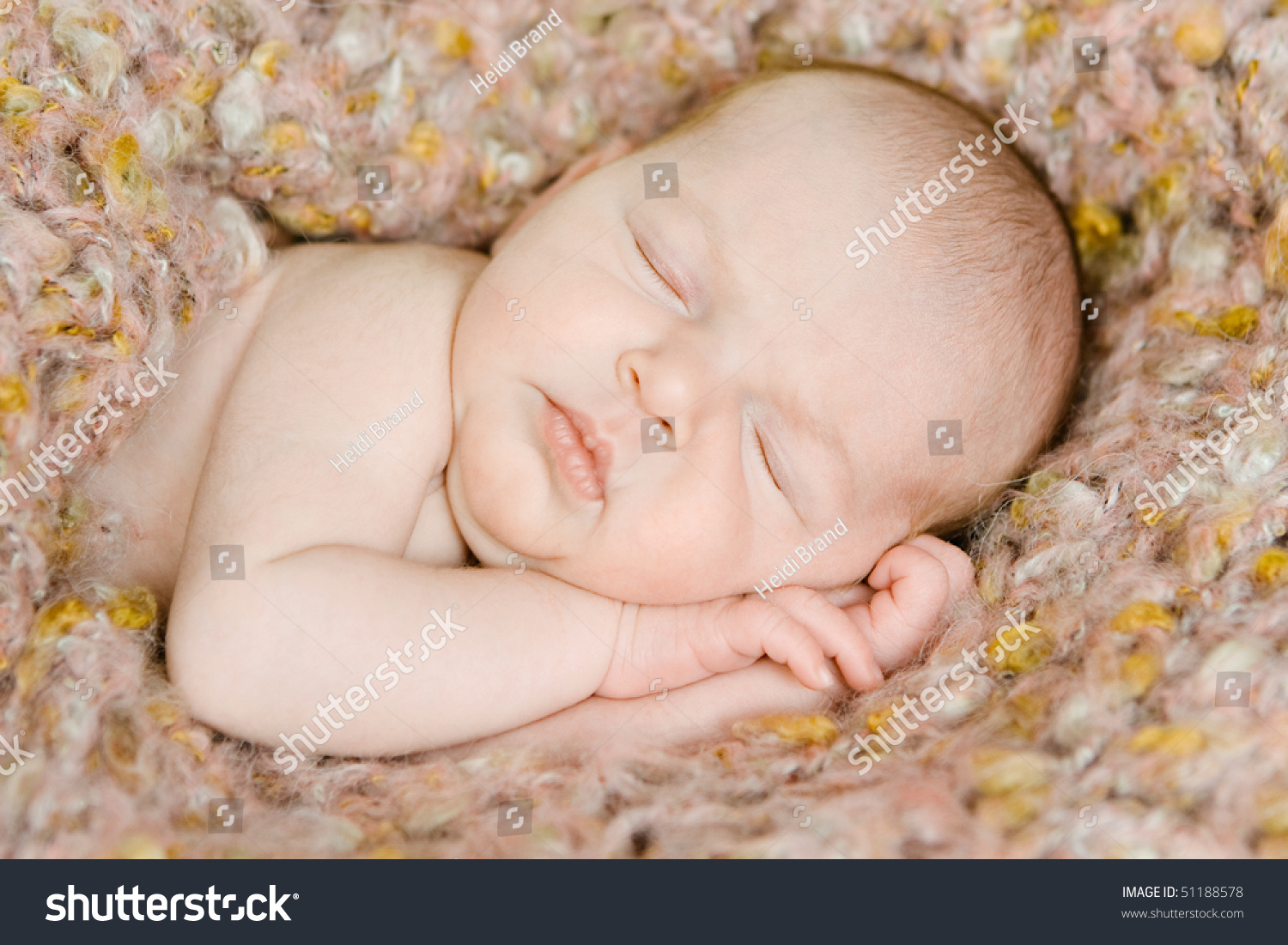 Closeup Of A Beautiful Newborn Baby Wrapped In A Blanket Sleeping Stock