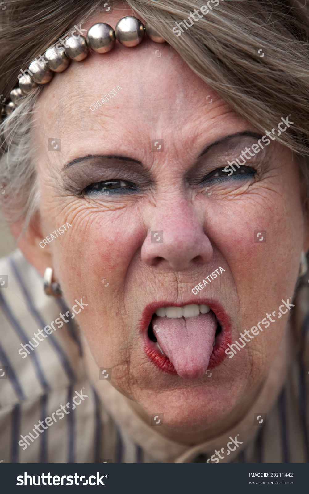 Closeup Of Rude Old Woman Sticking Out Her Tongue Stock Photo 29211442