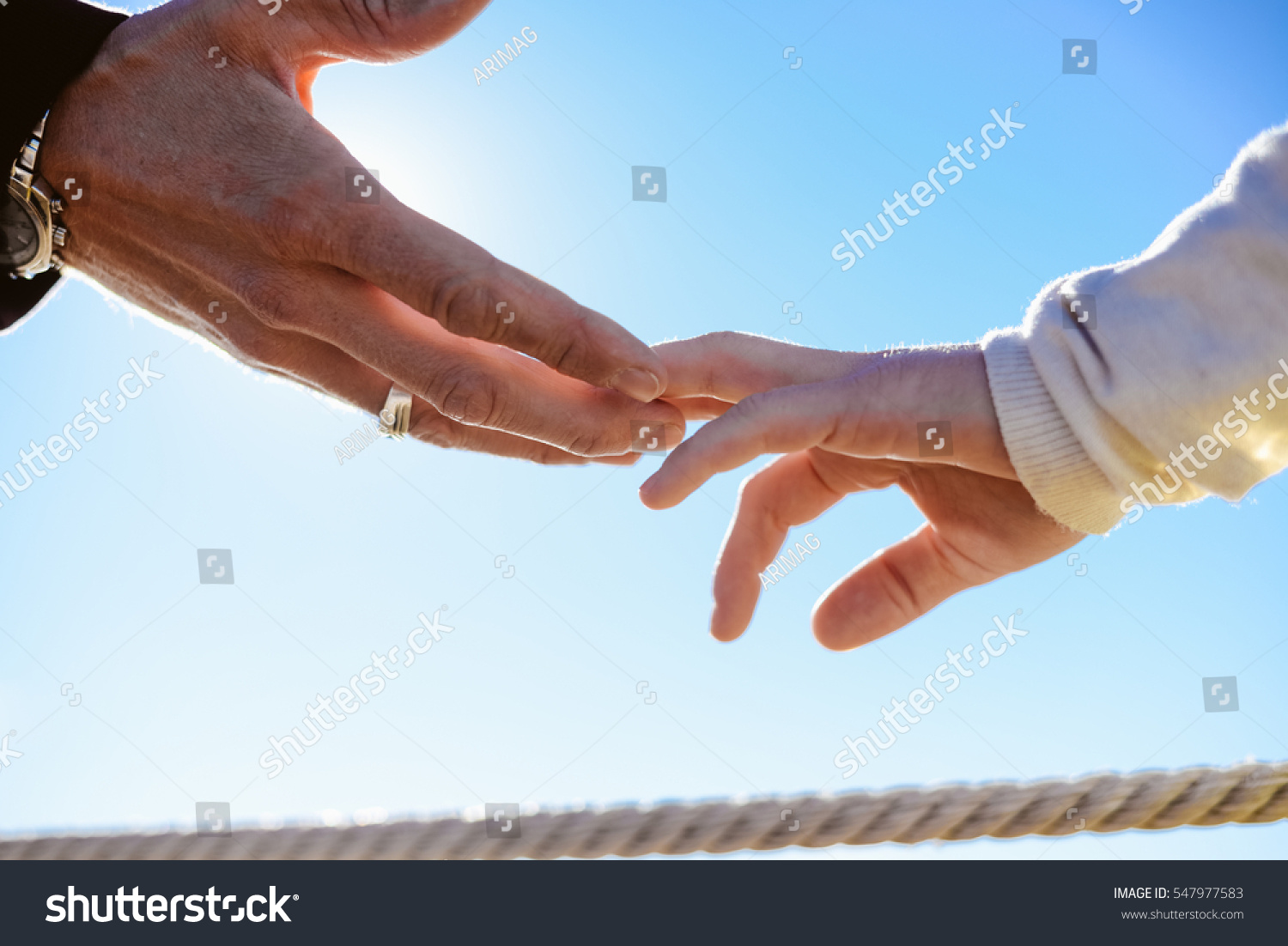 Closeup on hands Back view silhouette of male and female couple on holiday travel vacation outdoors background Blue sunny sky on lovely valentines day Closeup on hands Back view silhouette of male and female couple on holiday travel vacation outdoors background Blue sunny sky on lovely valentines day