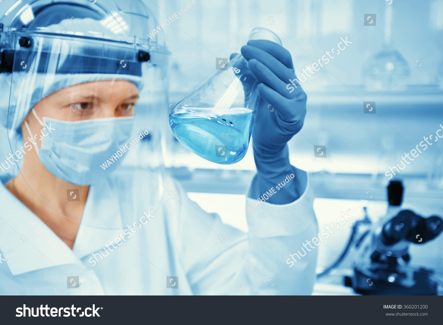 Closeup portrait female scientist holding conical tube with liquid solution laboratory experiments isolated lab background Forensics genetics microbiology biochemistry Closeup portrait female scientist holding conical tube with liquid solution laboratory experiments isolated lab background Forensics genetics microbiology biochemistry