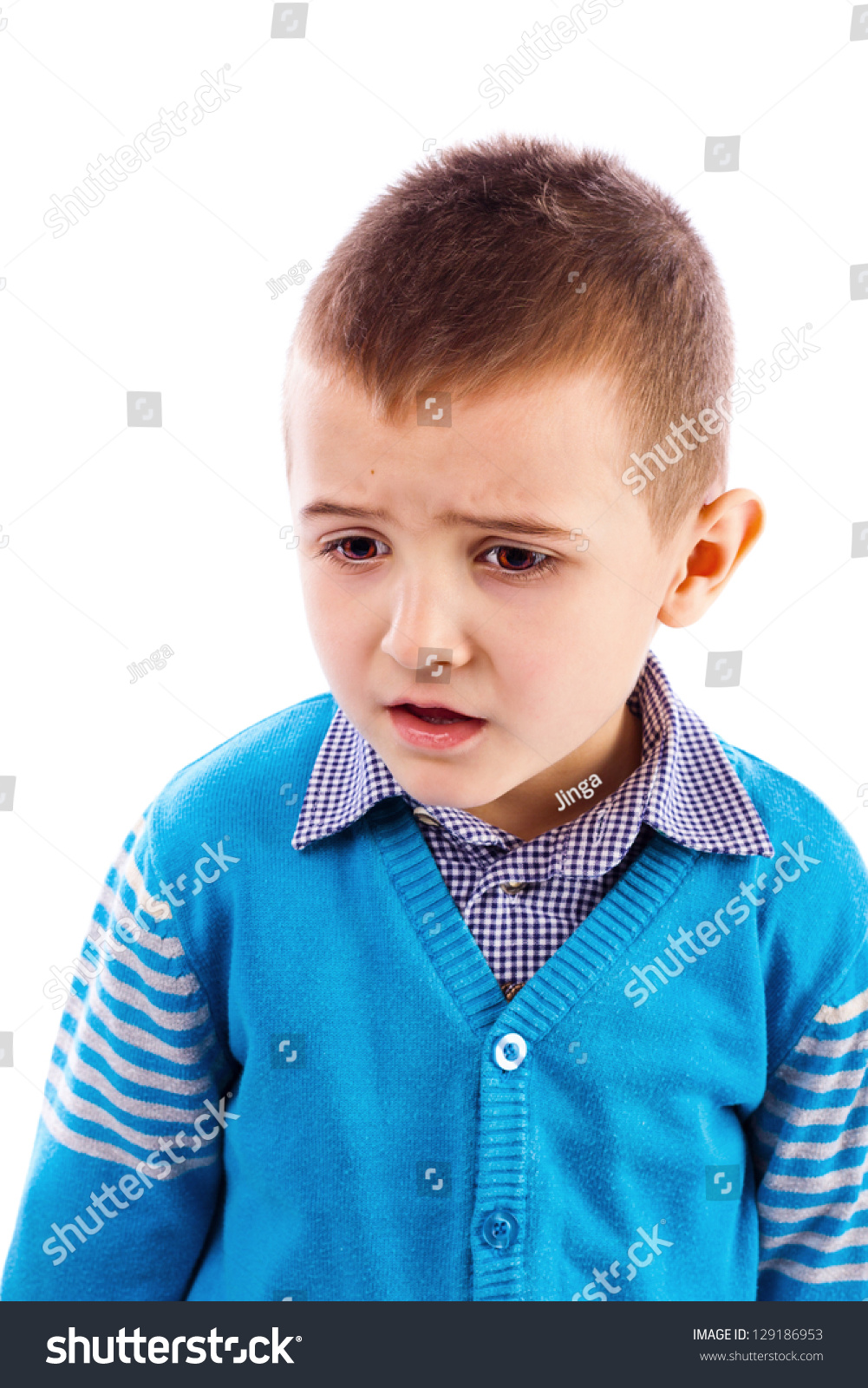 Closeup Portrait Of A Disappointed Cute Little Boy Against White