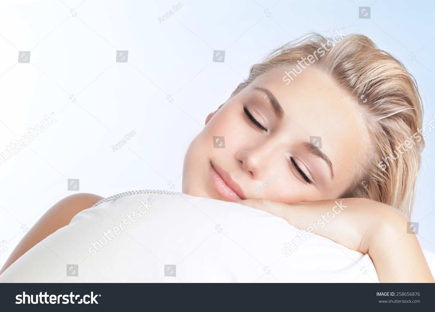 Closeup Portrait Of Beautiful Woman Sleeping On The Pillow Isolated On Blue And White Background
