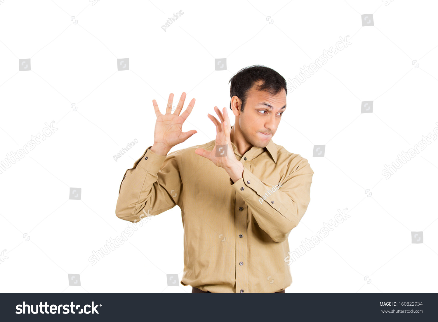 Closeup Portrait Of Handsome Young Guy Man In Brown Shirt Putting