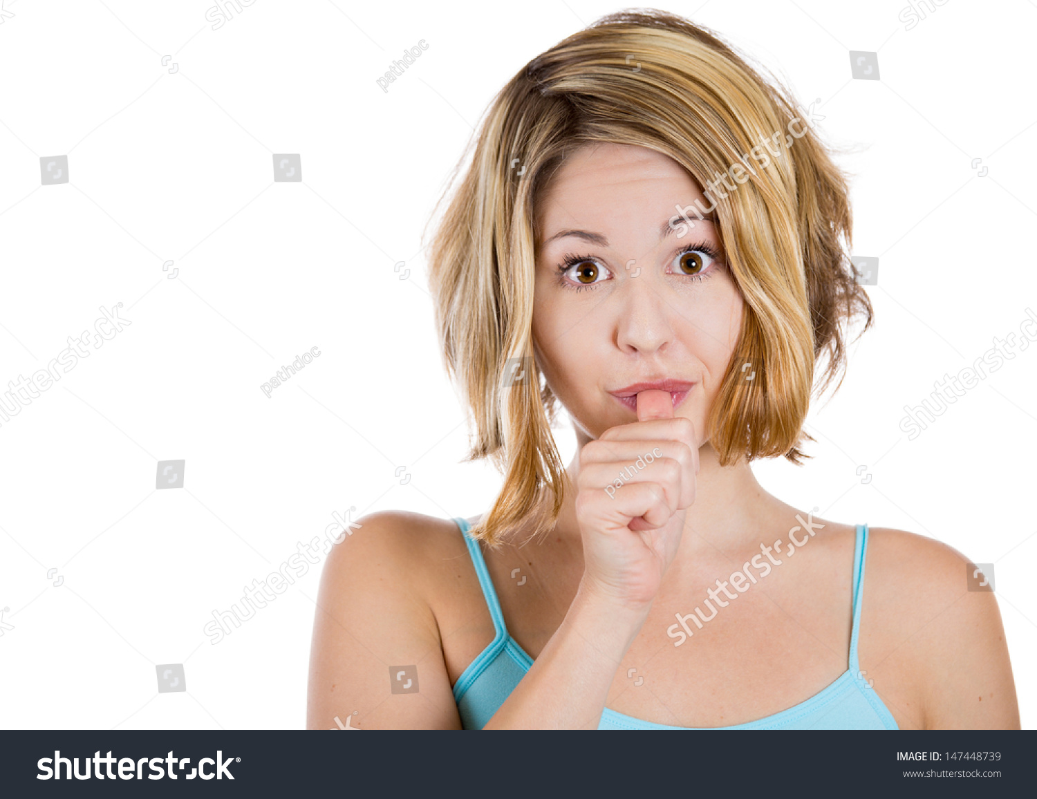 Closeup Portrait Of Woman With Finger In Mouth Sucking Thumb Or Biting Fingernail In Anxiety