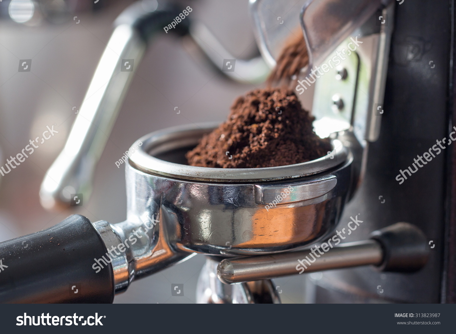 coffee-grinder-grinding-freshly-roasted-coffee-beans-into-a-coffee