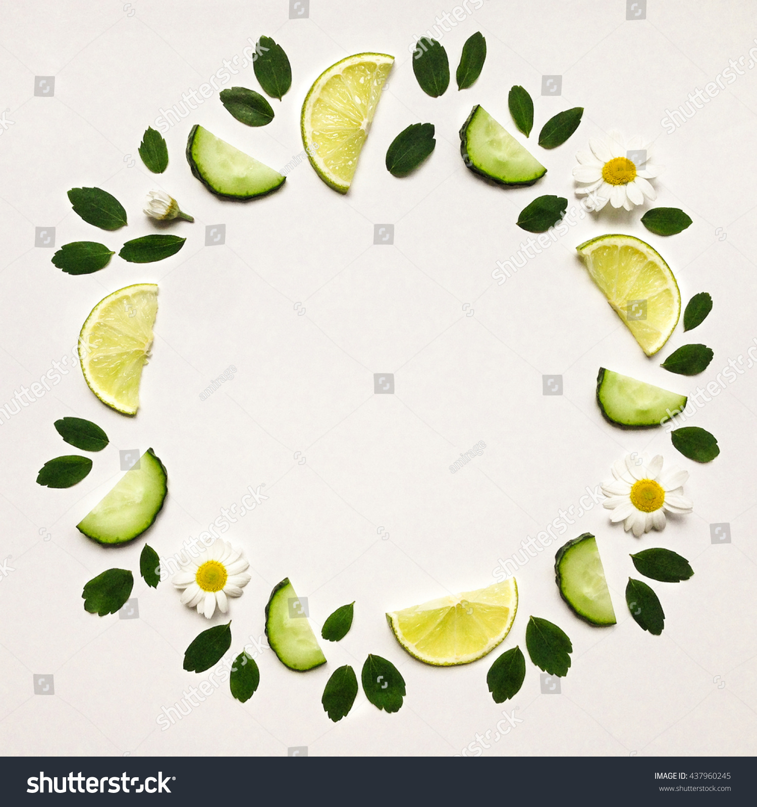 Colorful frame with fresh citrus fruits cucumbers leaves and flowers Flat lay on white table Colorful frame with fresh citrus fruits cucumbers leaves and flowers Flat lay on white table