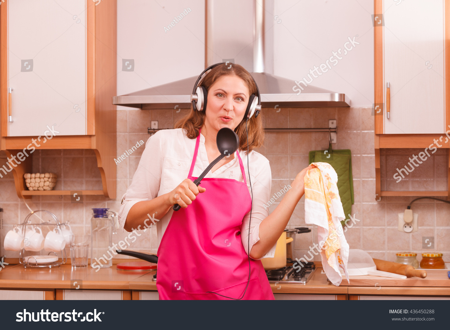 Young Woman Cooking And Wearing Apron In The Kitchen Stock 