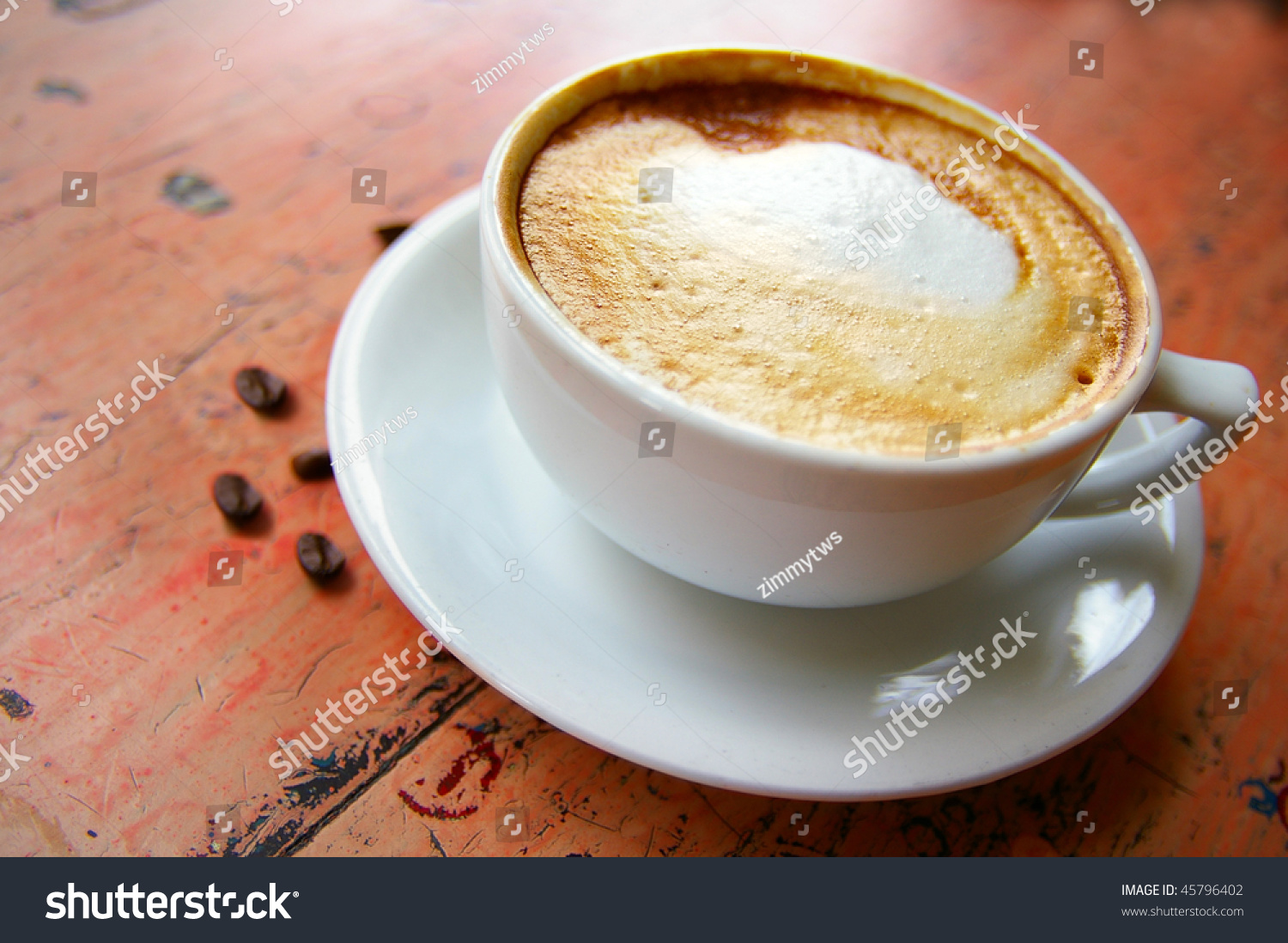 Cup Of Frothy Cappuccino Coffee With Coffee Beans Stock Photo 45796402 ...