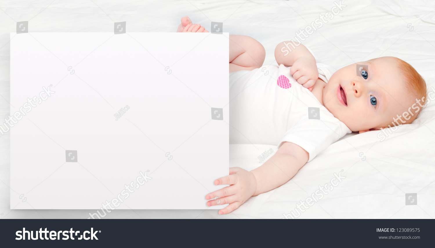Cute Baby Girl Lying on Back Holding Sign Cute Baby Girl Lying on Back Holding Sign