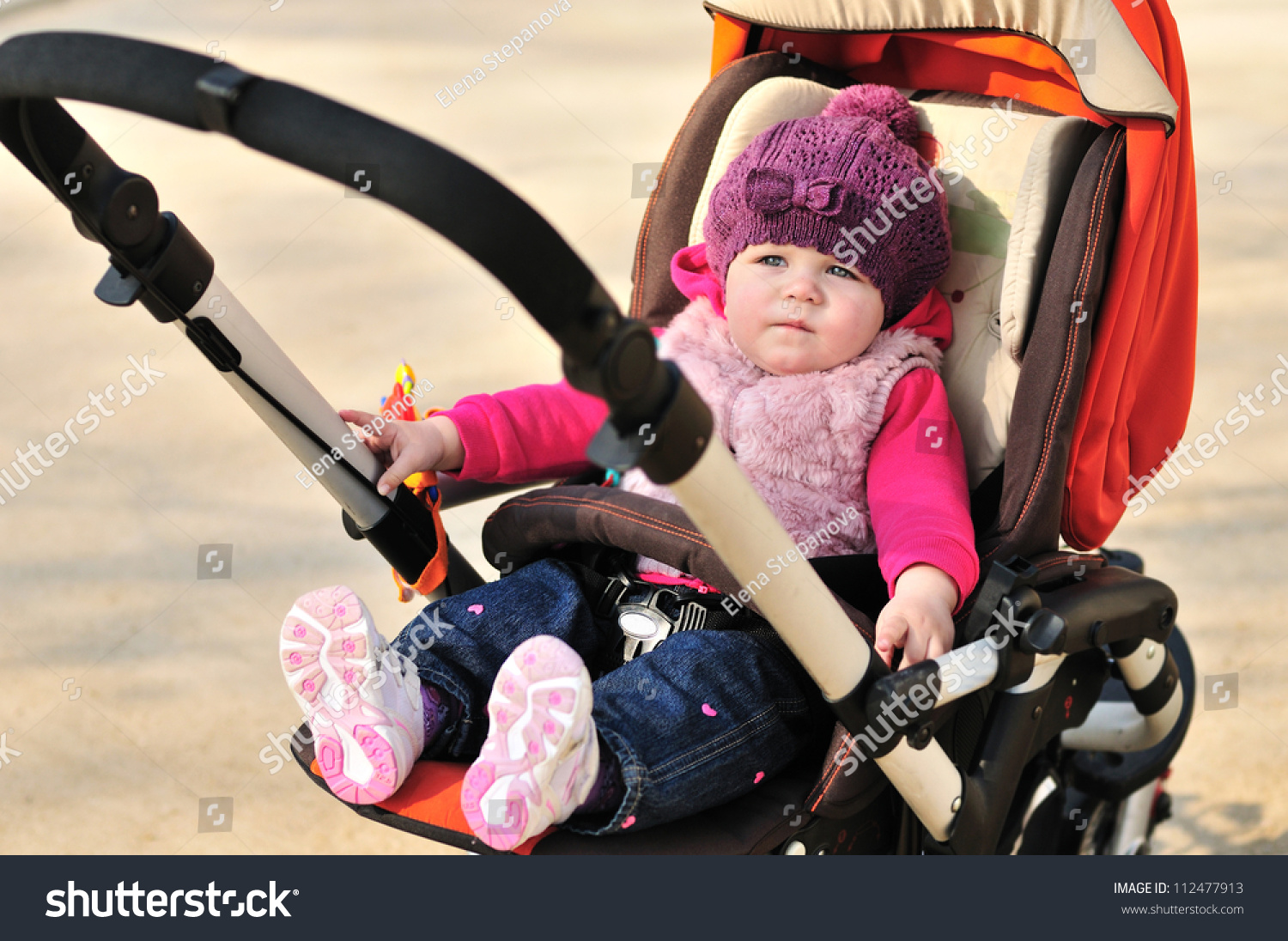 cute baby girl sitting in stroller stock photo 112477913   shutterstock