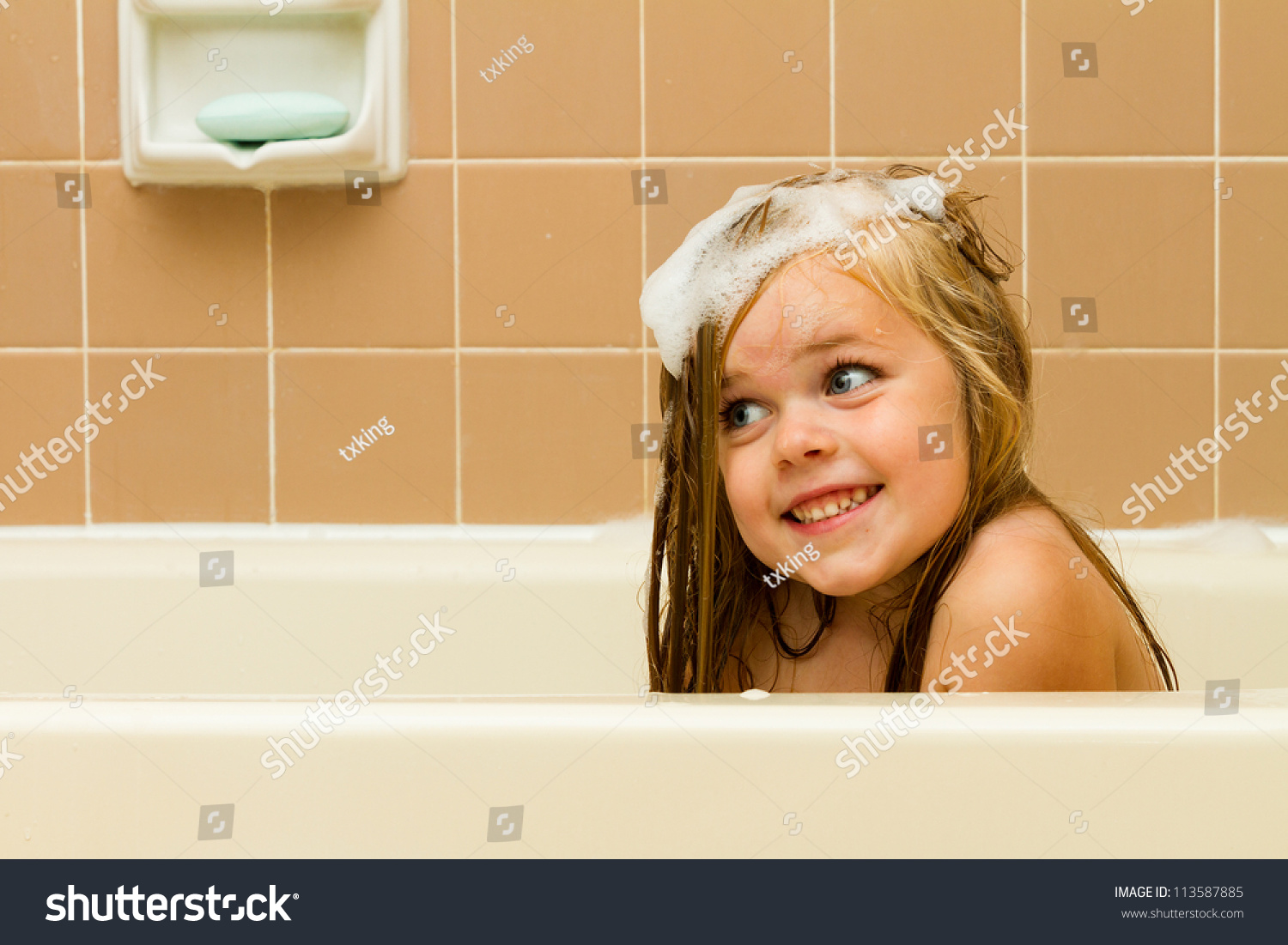 Cute Photo Of A Girl Smiling With Soap Suds In Her Hair While Playing In The Tub 113587885 0106