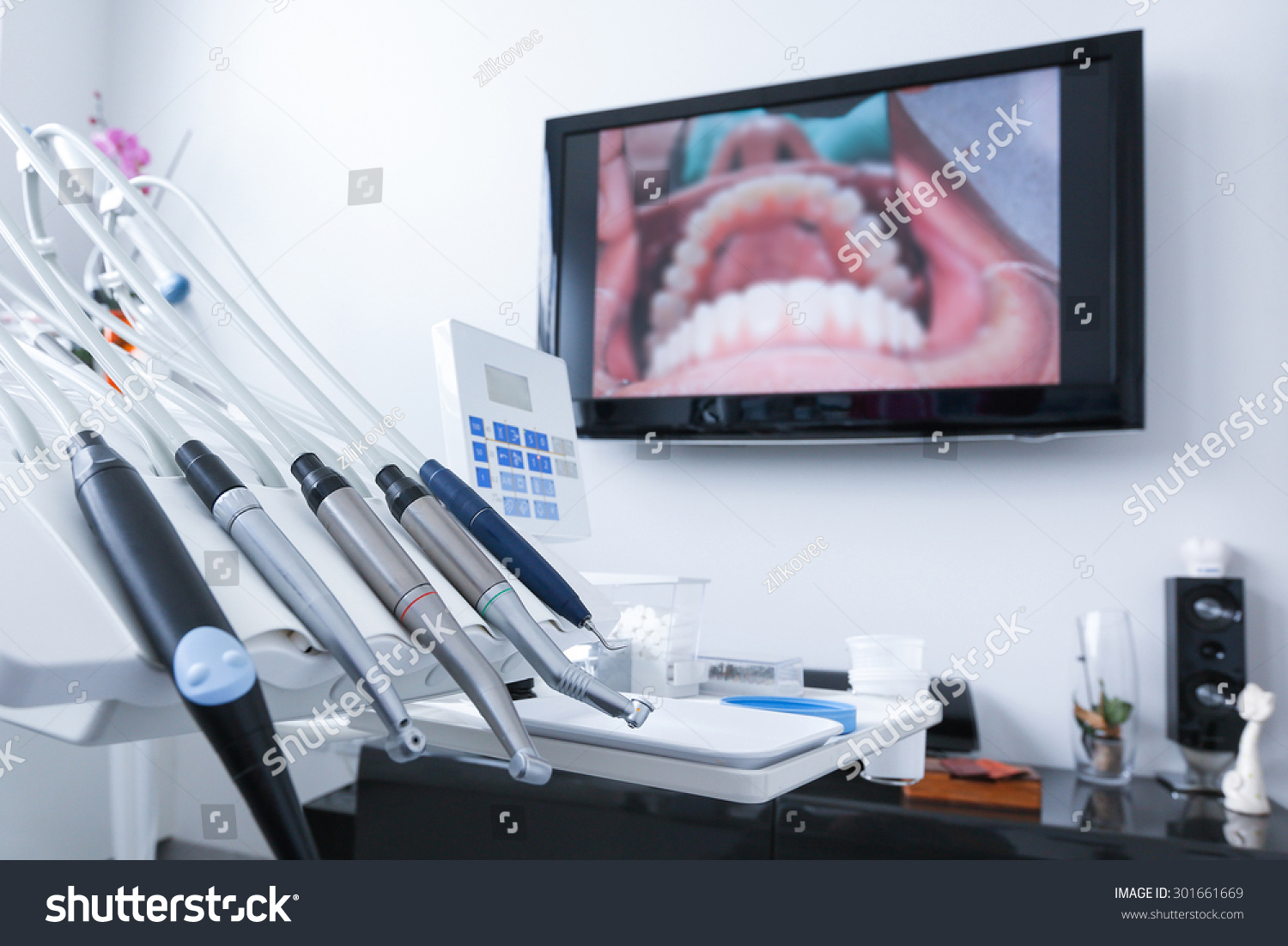 Dental office specialist tools drills handpieces and laser with live picture of teeth in the background Dental care dental hygiene checkup and therapy concept Dental office specialist tools drills handpieces and laser with live picture of teeth in the background Dental care dental hygiene checkup and therapy concept