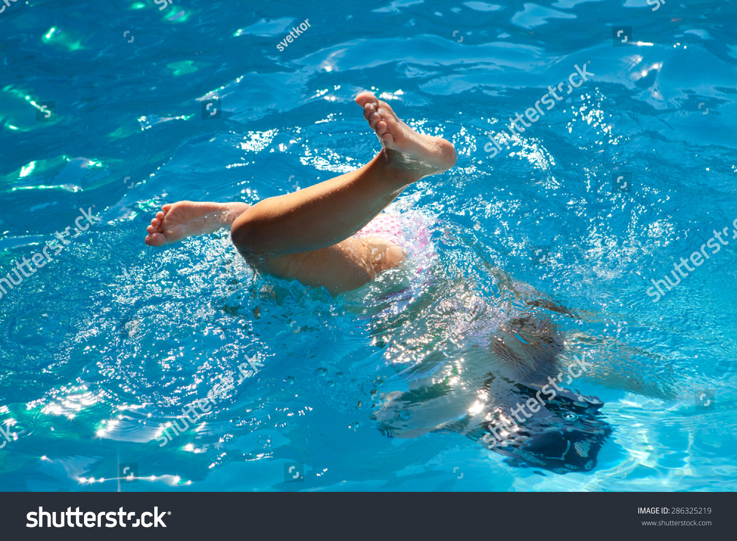 Diving child in the swimming pool Diving child in the swimming pool