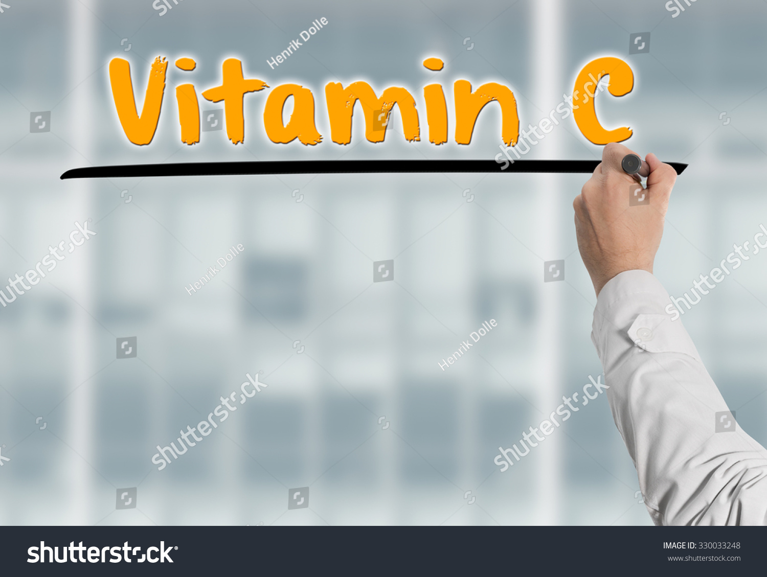Doctor writes on a glas wall the headline Vitamin C Doctor writes on a glas wall the headline Vitamin C