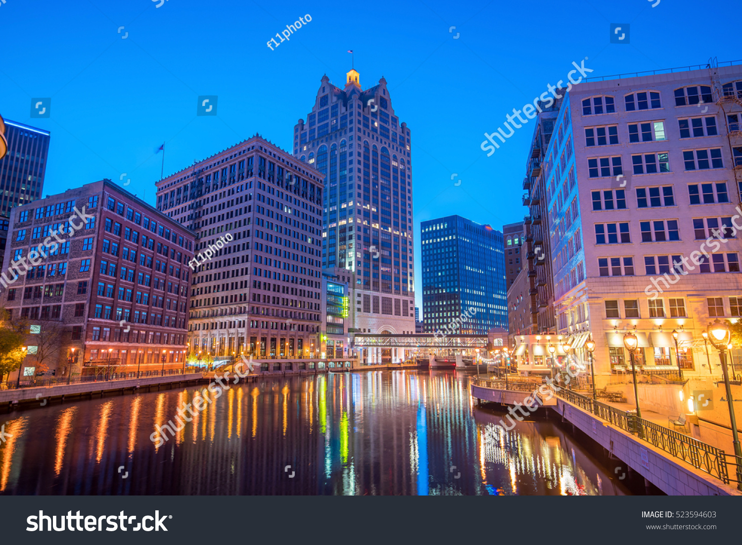 Downtown skyline with Buildings along the Milwaukee River at night in Milwaukee Wisconsin Downtown skyline with Buildings along the Milwaukee River at night in Milwaukee Wisconsin
