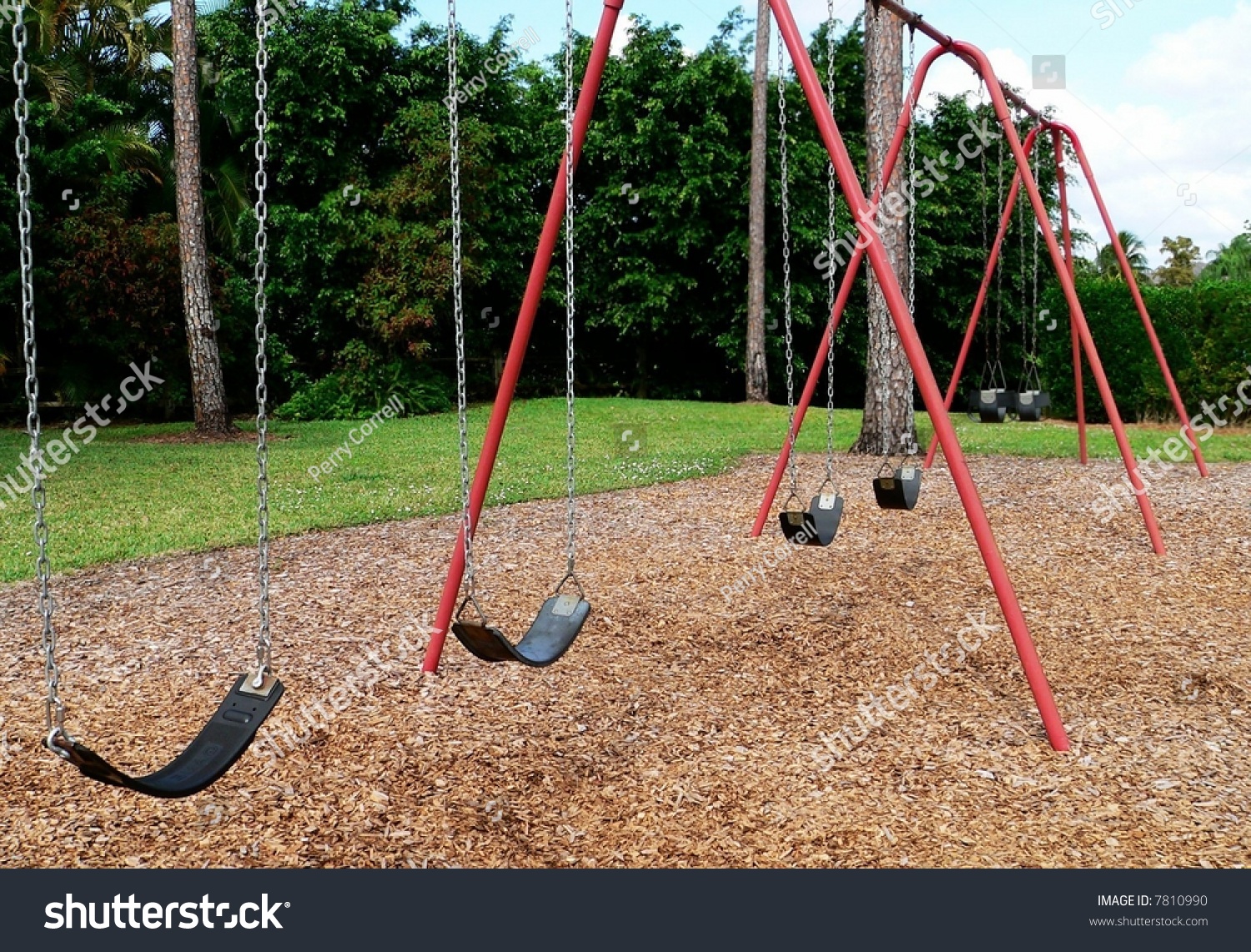Empty Swing Set On Playground There Are Six Swings On A Red Swing Set