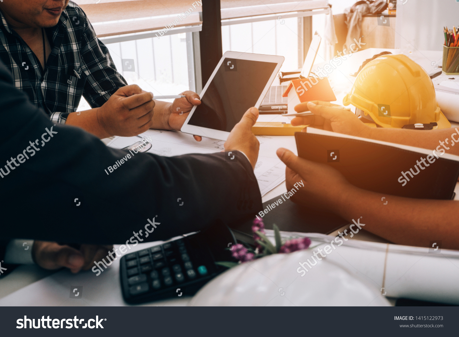 Engineers Pointing Building On Blueprint Using Stock Photo