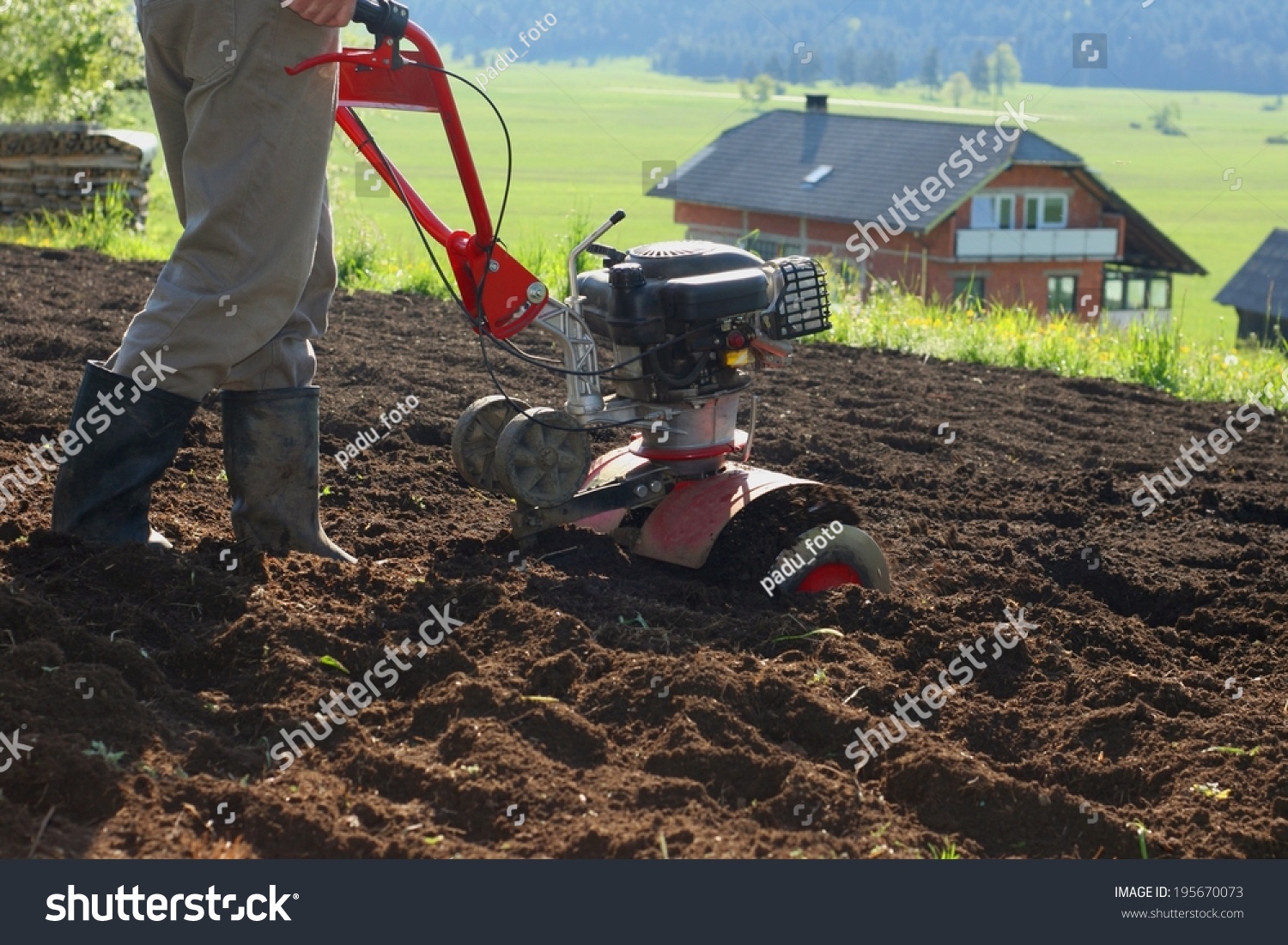 Farmer Using Modern Mechanical Rotary Tiller Stock Photo 195670073