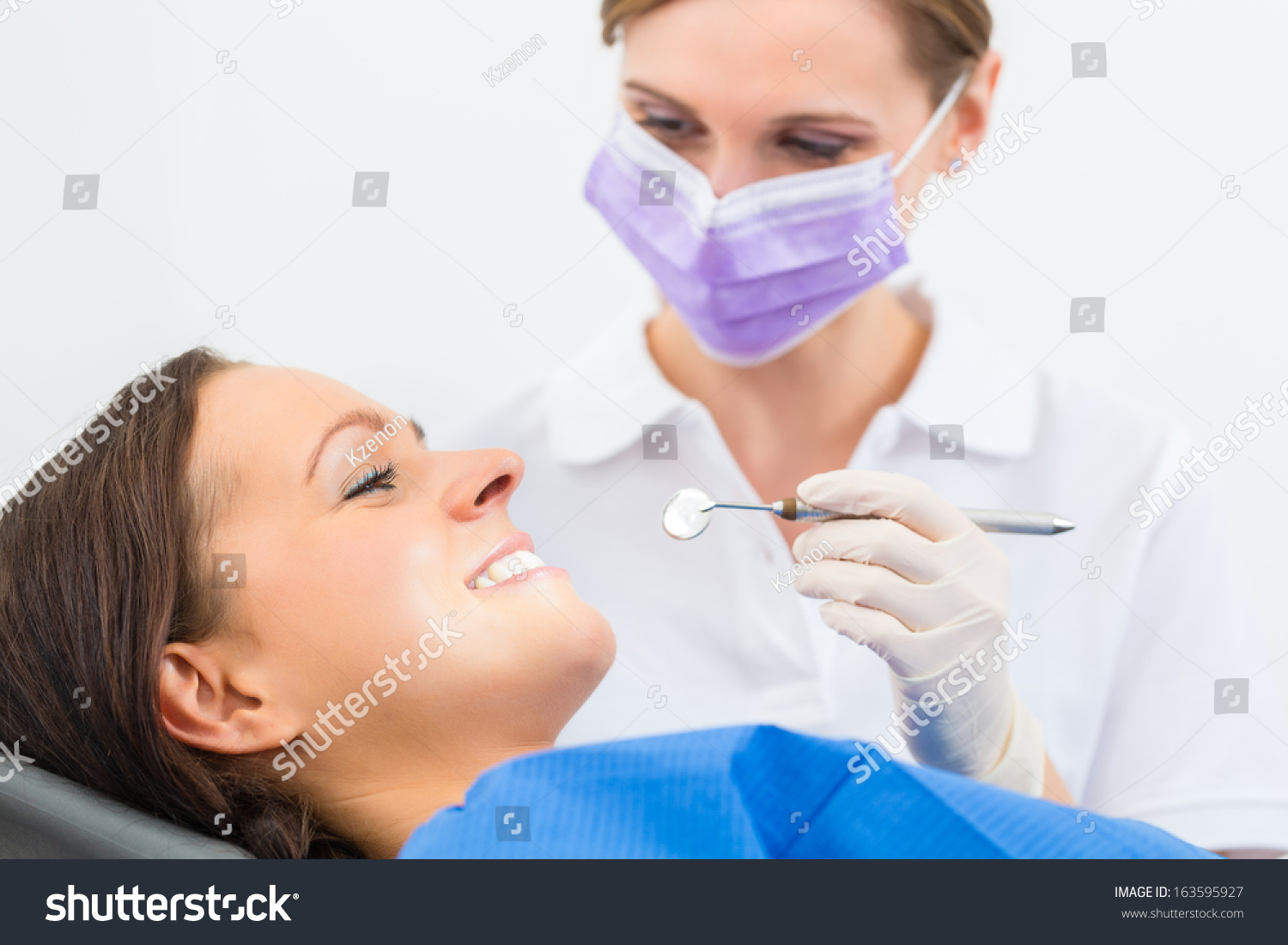 Female Patient With Dentist In A Dental Treatment, Wearing Masks And ...