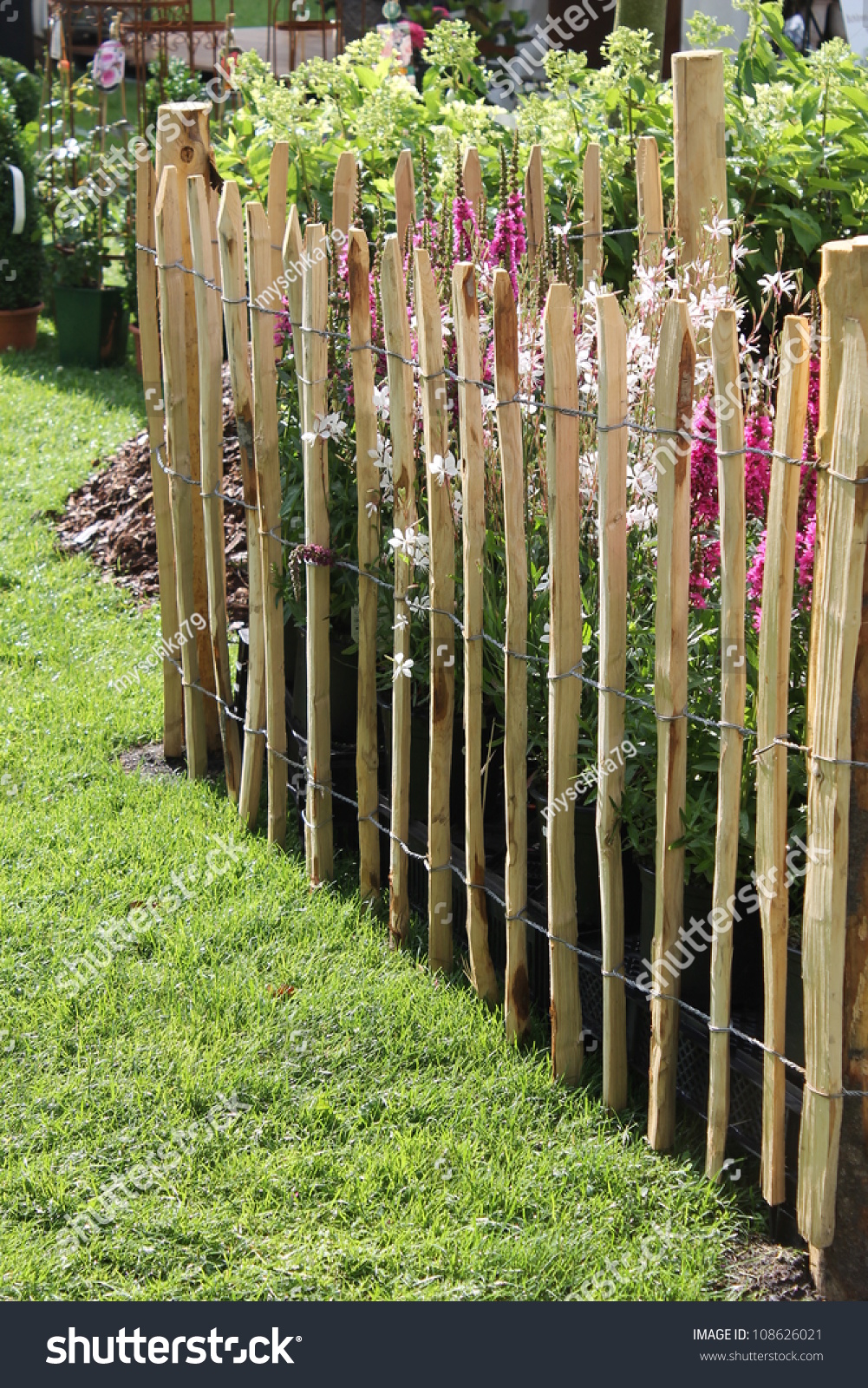 Fence Of Wooden Peg On The Diagonal With Flowers Stock Photo 108626021 